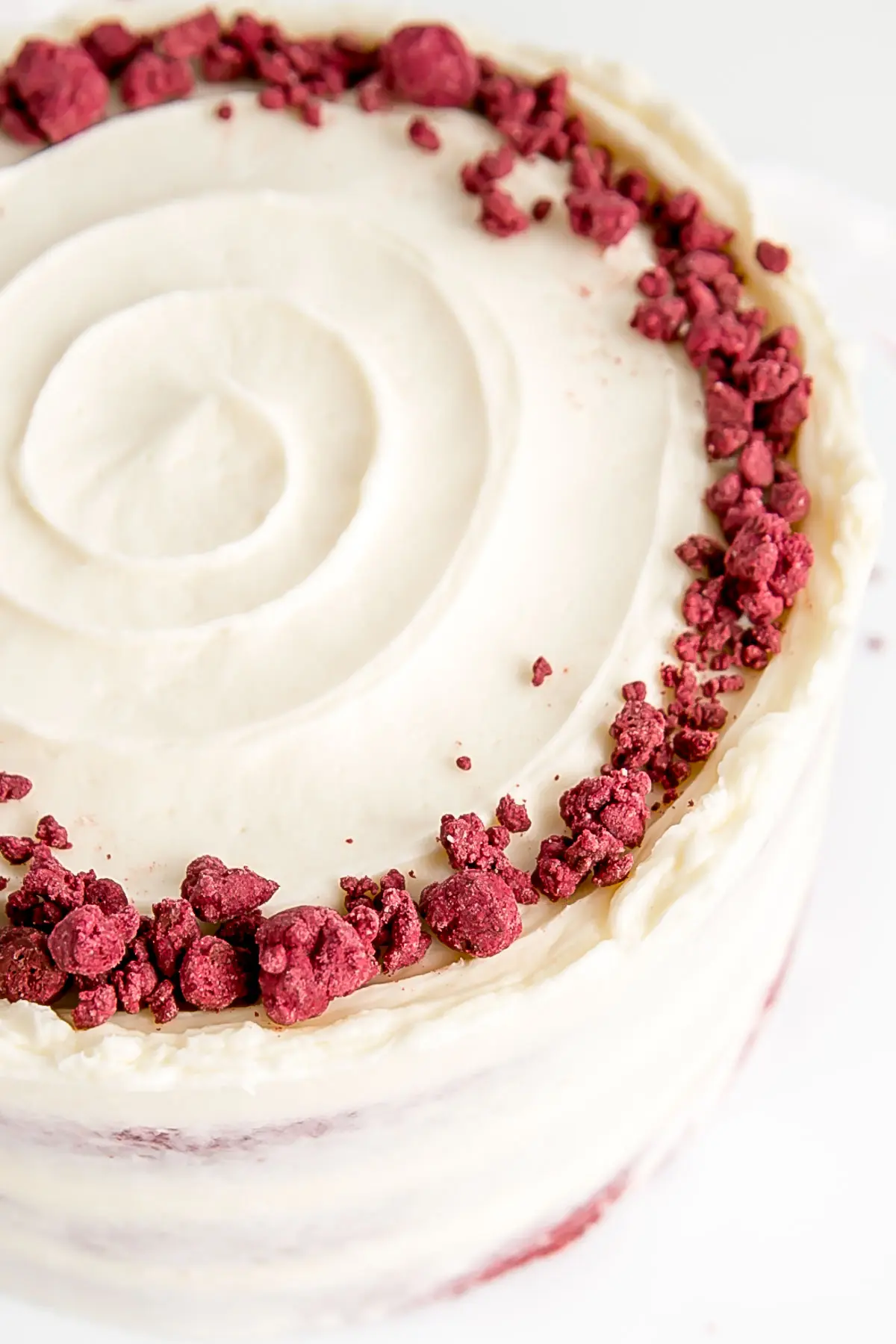 Angled shot of the red velvet crumble on the cake.