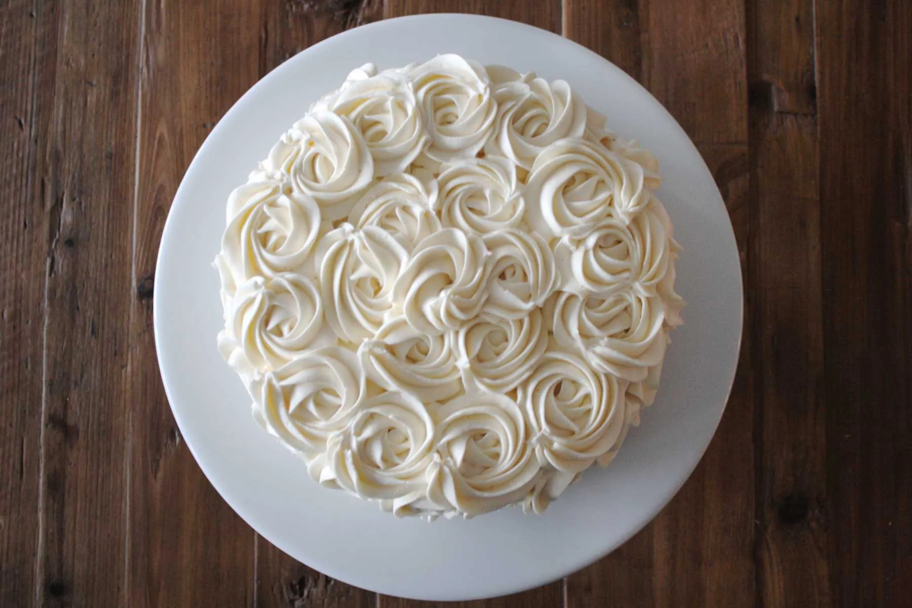 Overhead shot of buttercream rosettes on a cake.