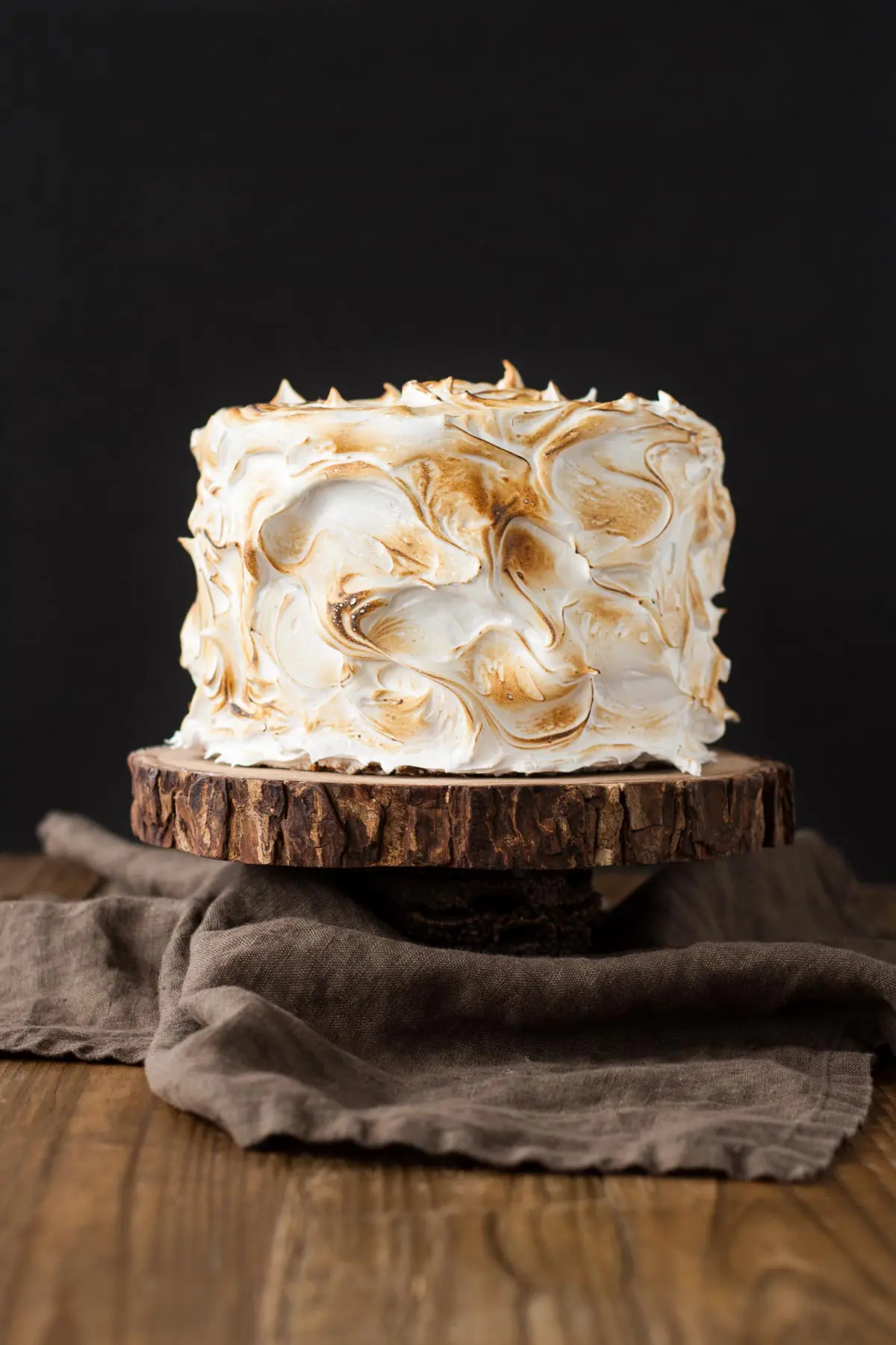 Cake on a rustic wooden stand.