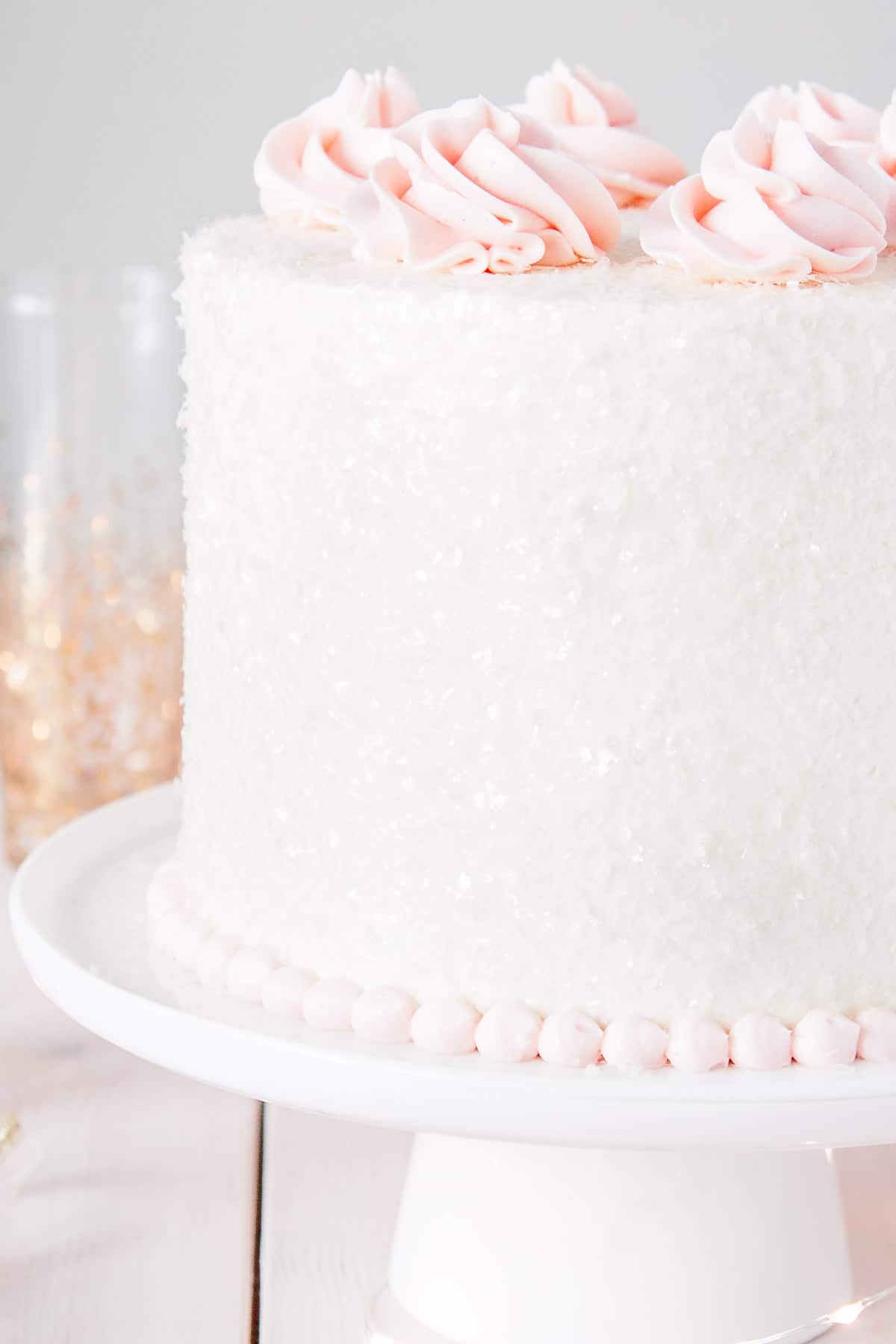 Close up of cake sparkles on a pink champagne cake.