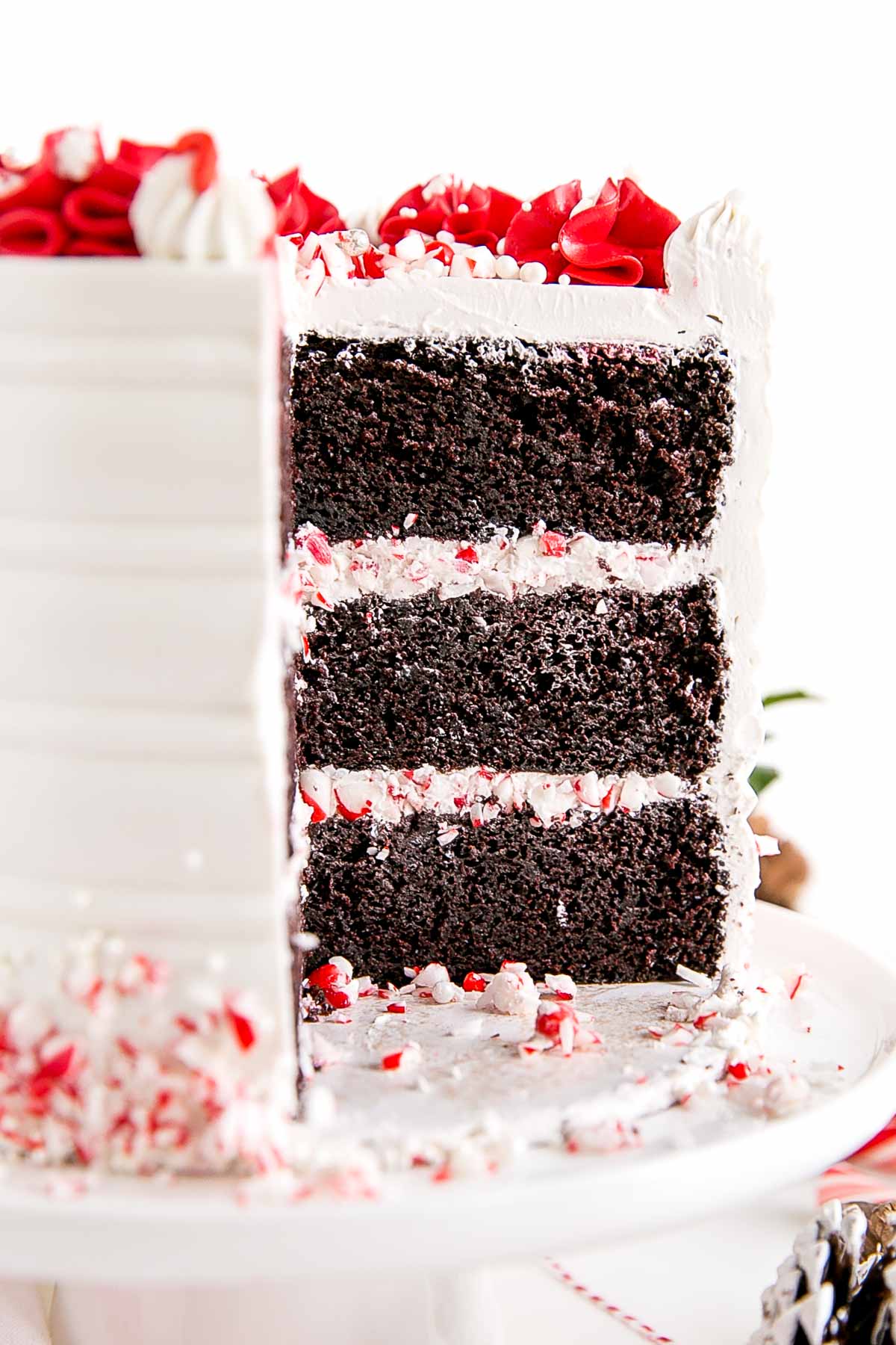 Cross-section showing the chocolate cake layers and crushed candy canes and frosting between them.