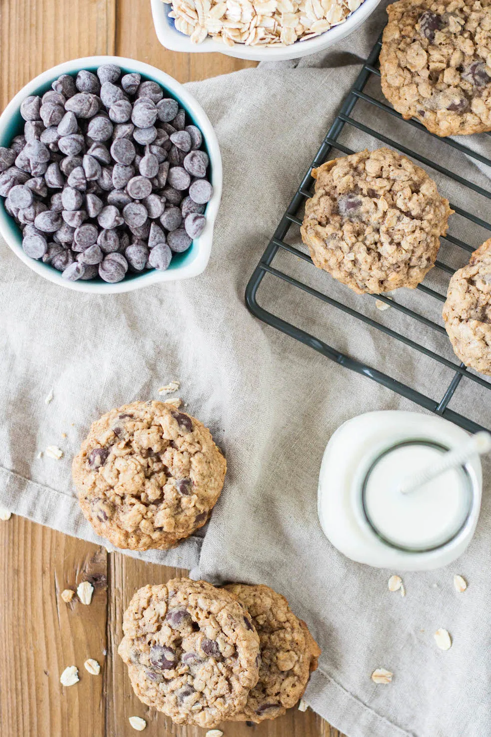 Chewy aatmeal chocolate chip cookies top down with chocolate chips and milk.