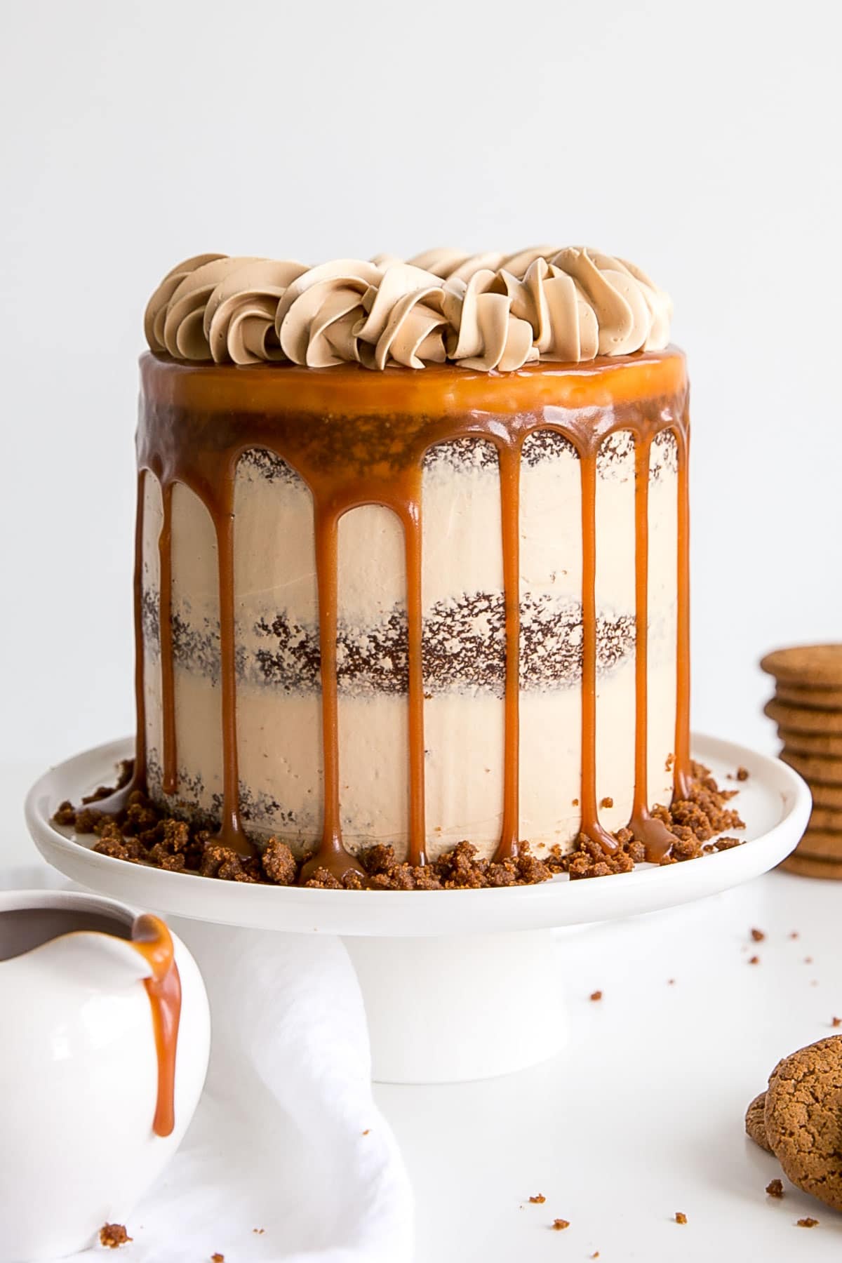 Gingerbread cake with caramel buttercream decorated naked cake style with a caramel drip.