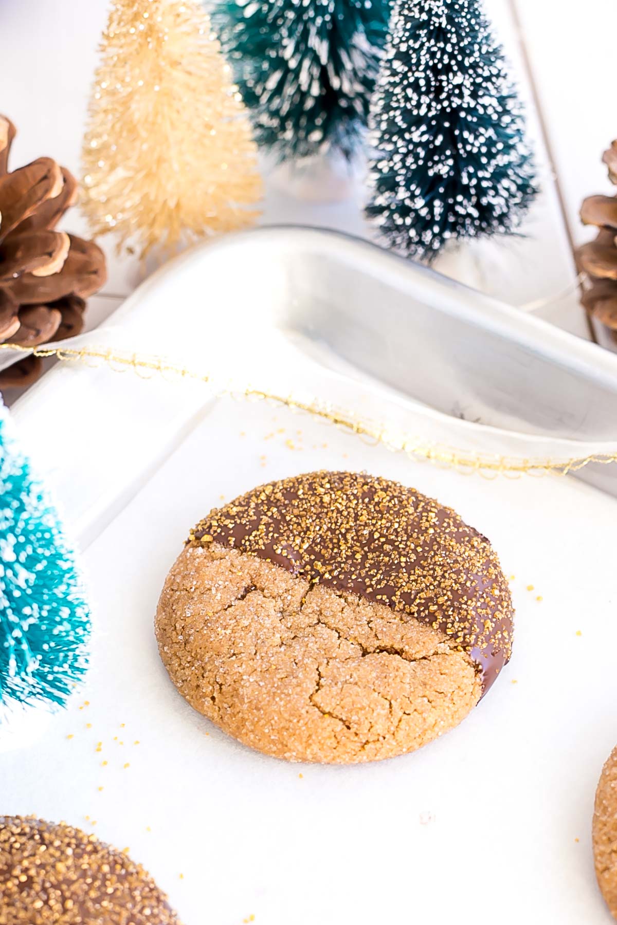 Chocolate dipped cookie on a baking sheet.