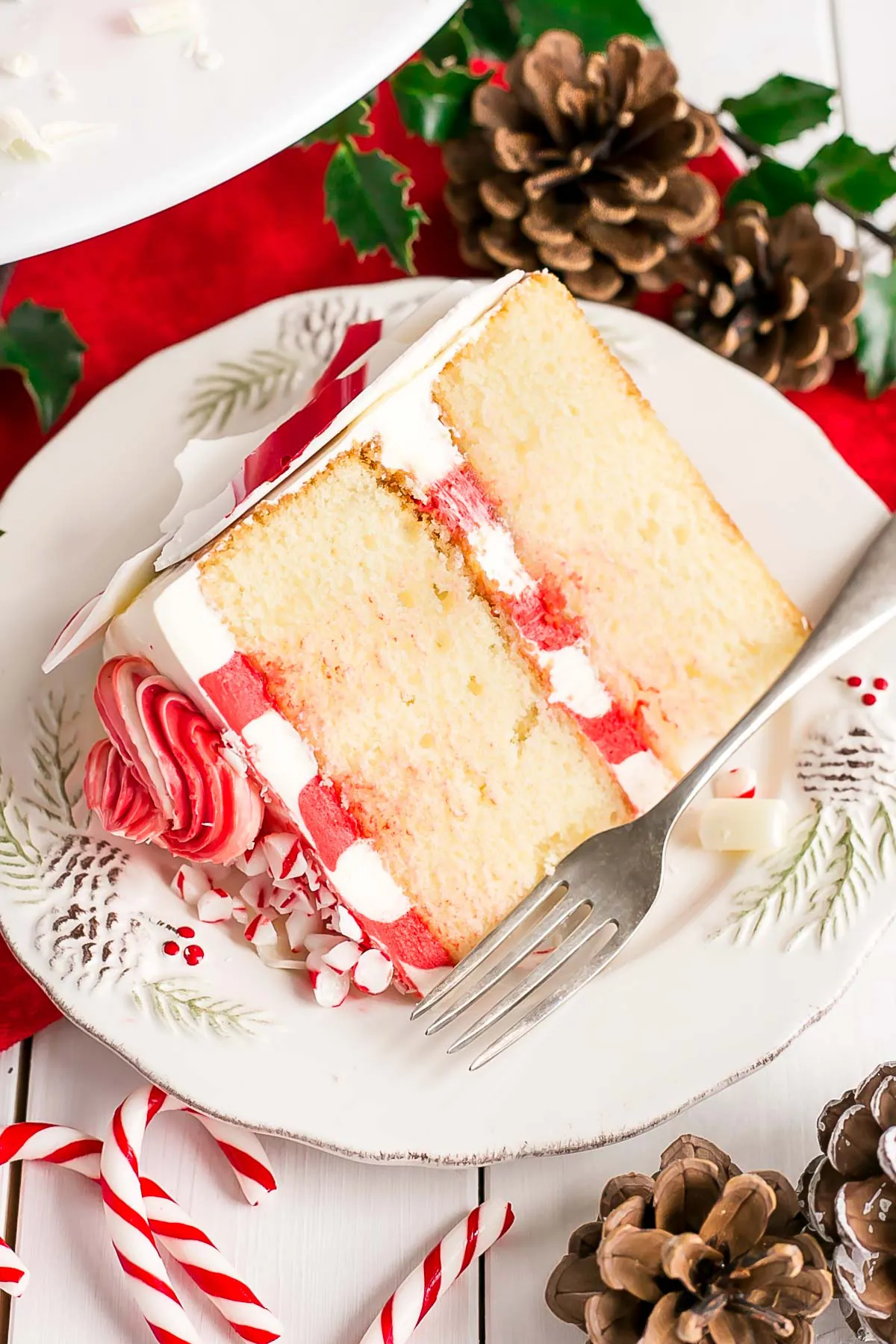 Slice of cake on a plate showing striped buttercream.