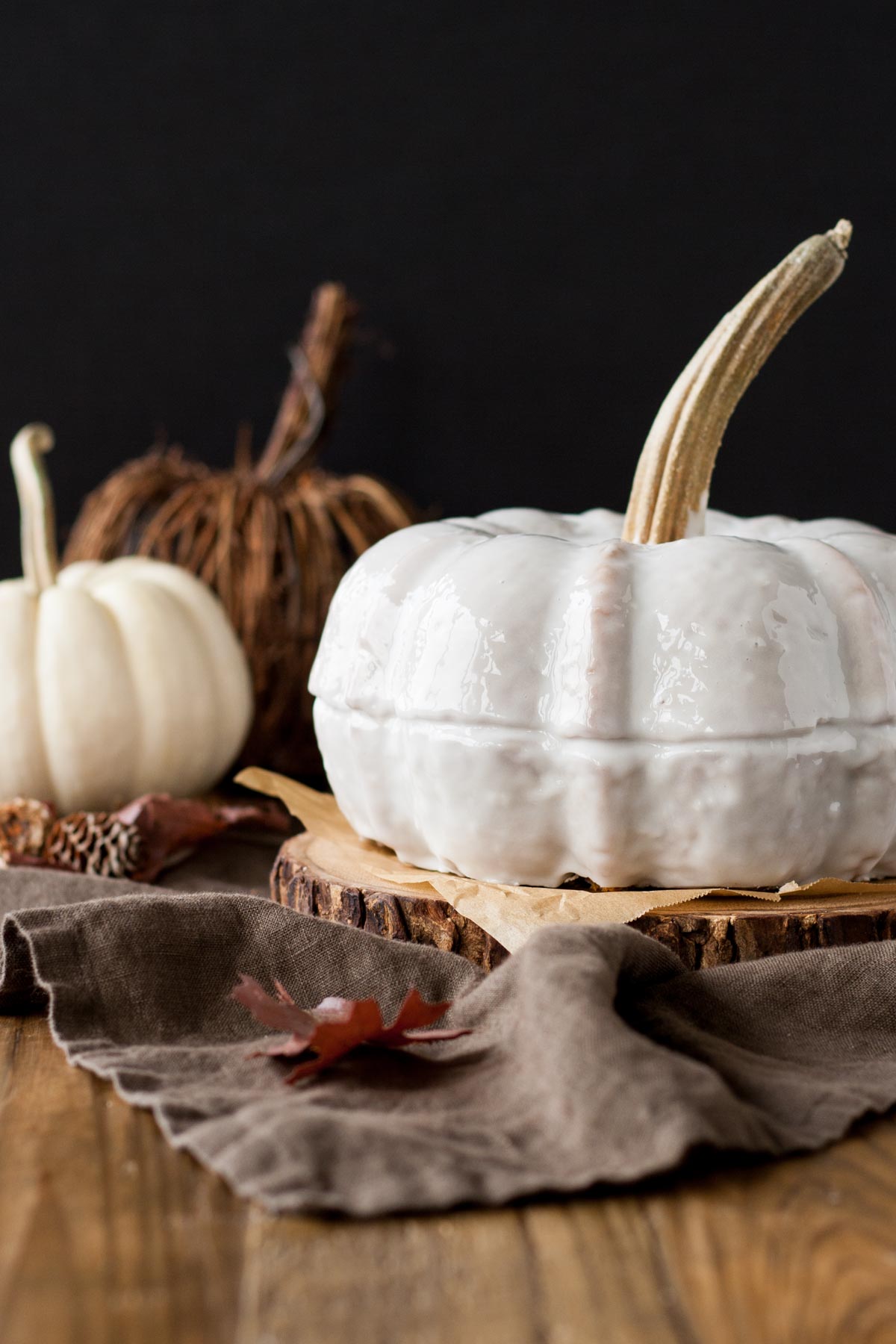 Bundt cake shaped to be a pumpkin on a black background.