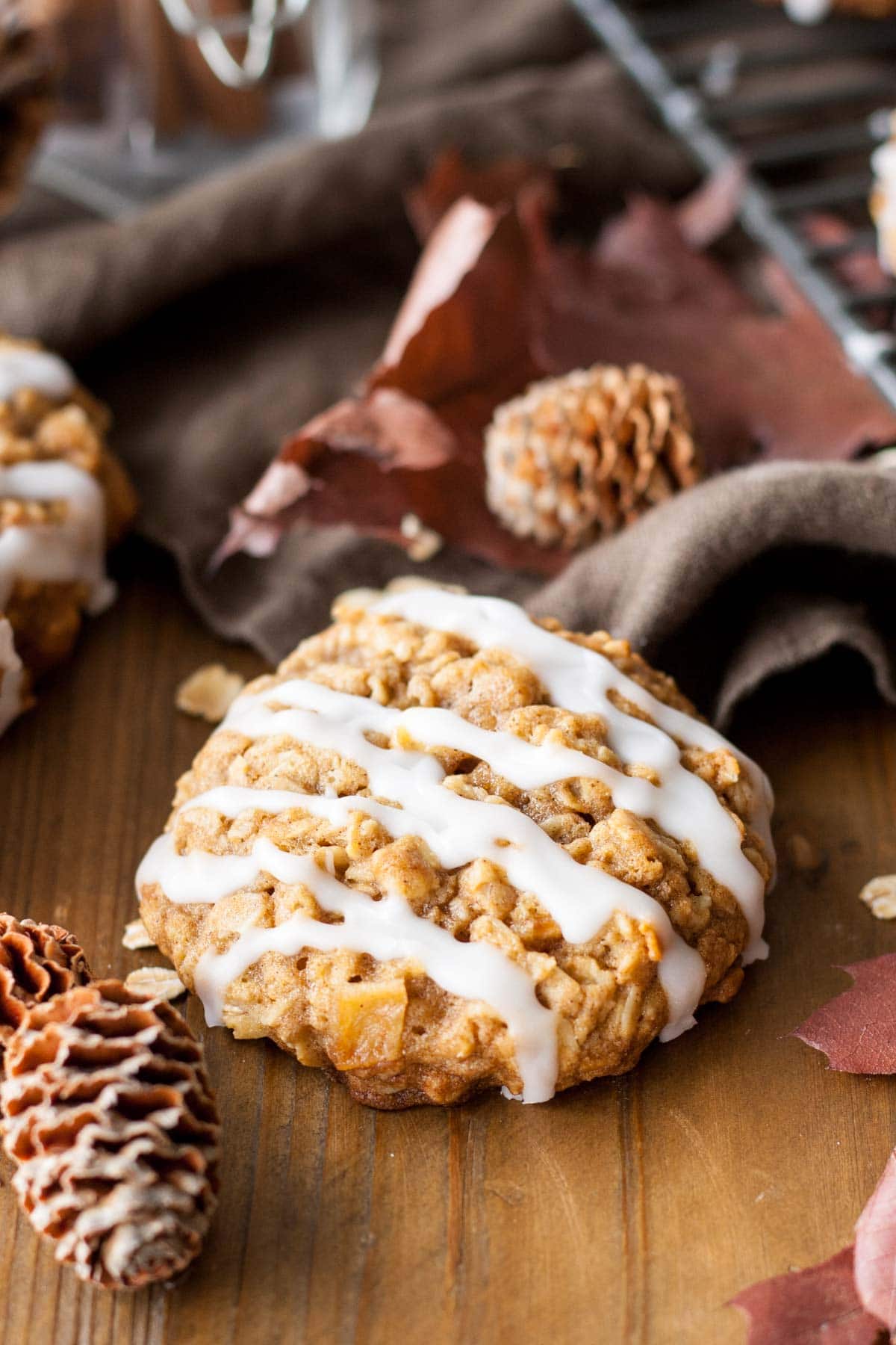 Cookie drizzled with glaze on a wooden table.