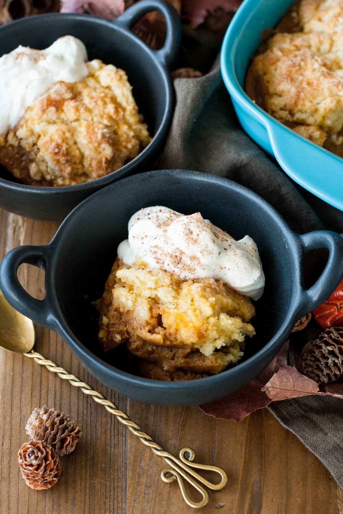 Close up of the cobbler in a bowl topped with whipped cream.