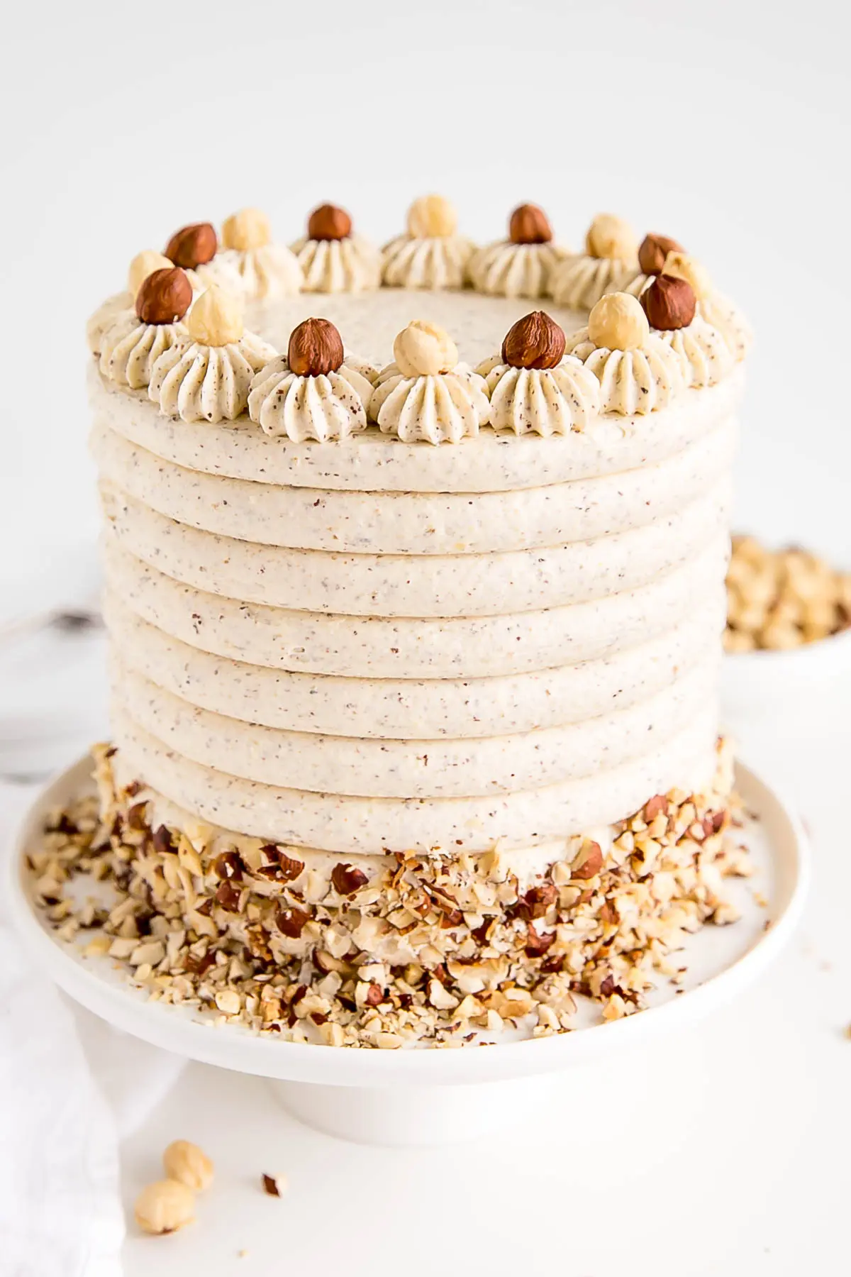 Angled shot of the cake on a white cake stand.