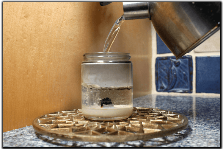 fill candle with boiling water to remove wax from jar