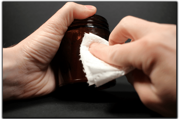 Wipe the jar with rubbing alcohol and paper towels to remove old adhesives