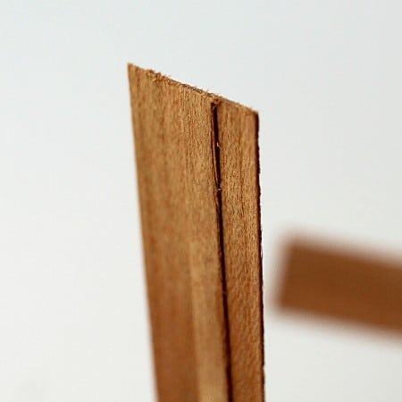 up close view of a wood wick with a booster strip down the middle