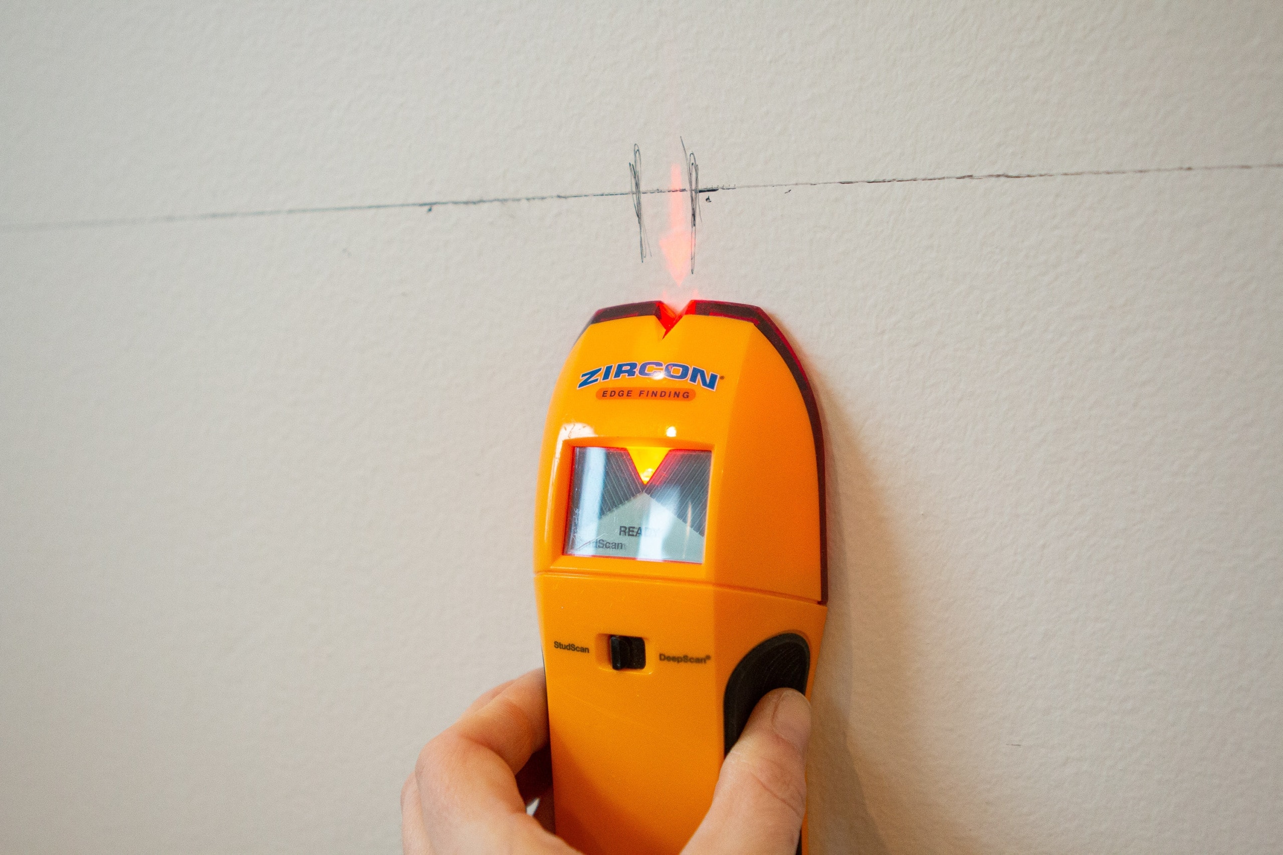 Using a stud finder to find studs