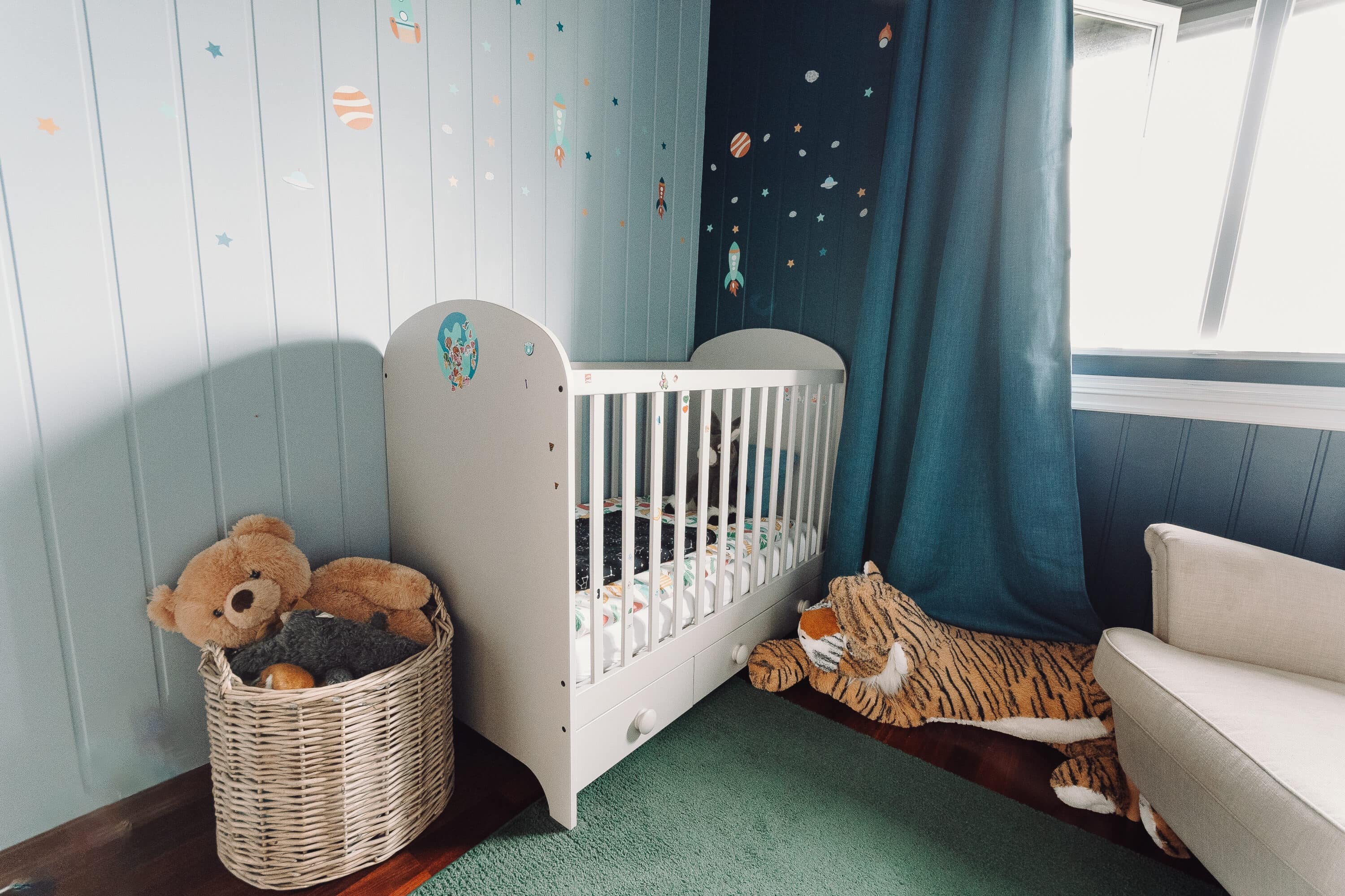 A nursery with dark walls and planks