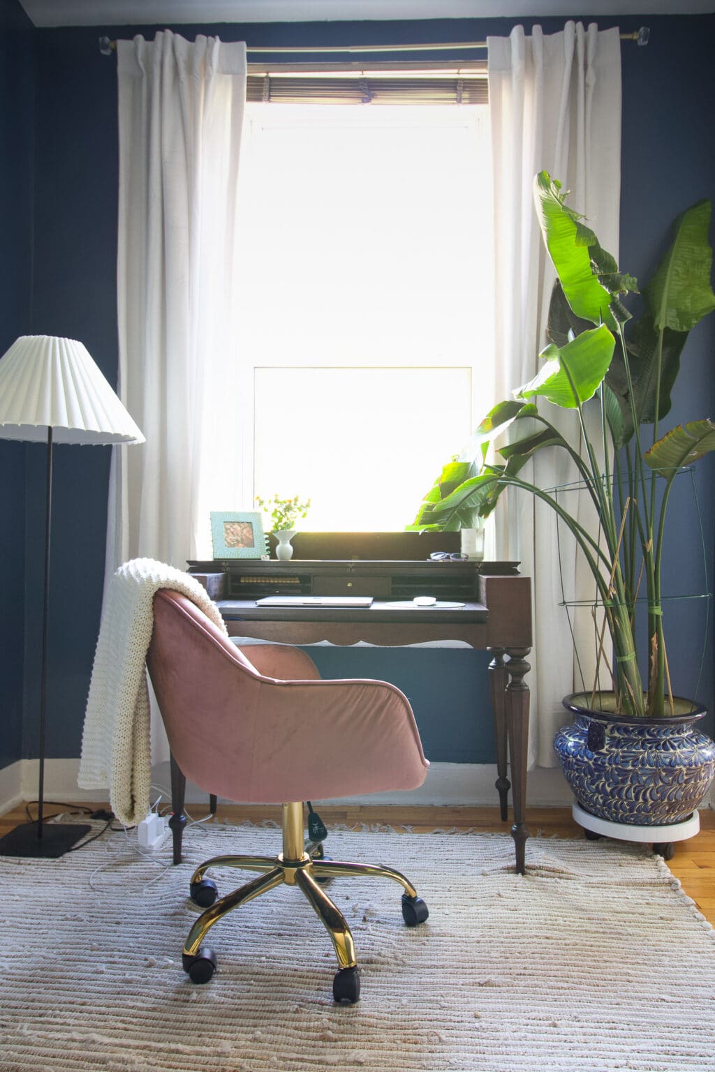 Molly's office with an antique desk and light pink chair