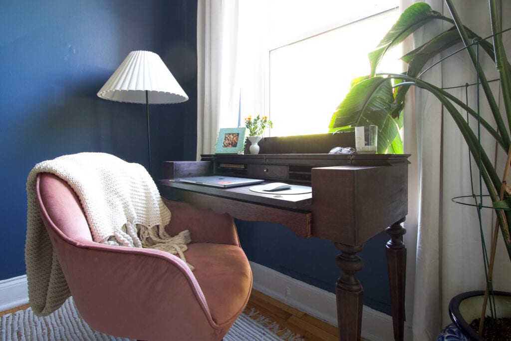 A wood antique desk in a home office space