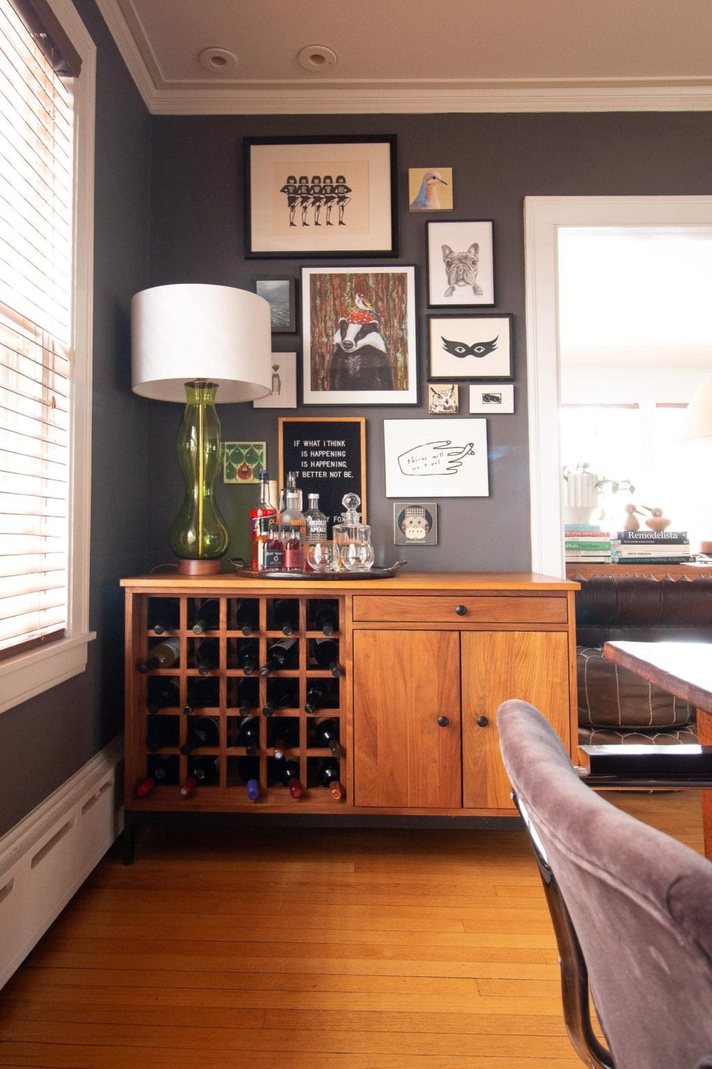 Gallery wall over a bar area in a dining room