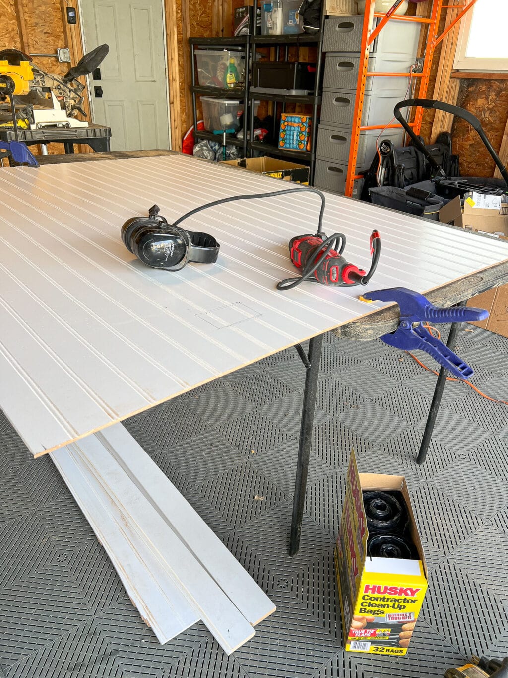 Using the oscillating multi-tool to cut out parts of the beadboard for outlets