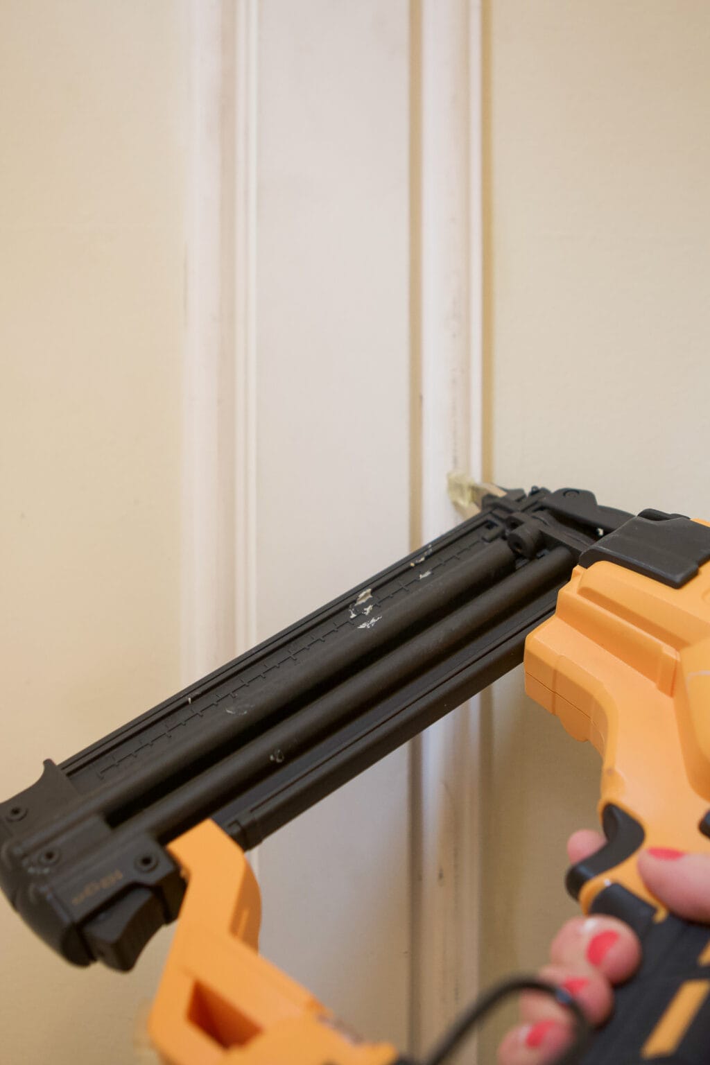 Use a brad nailer to lock the trim in place