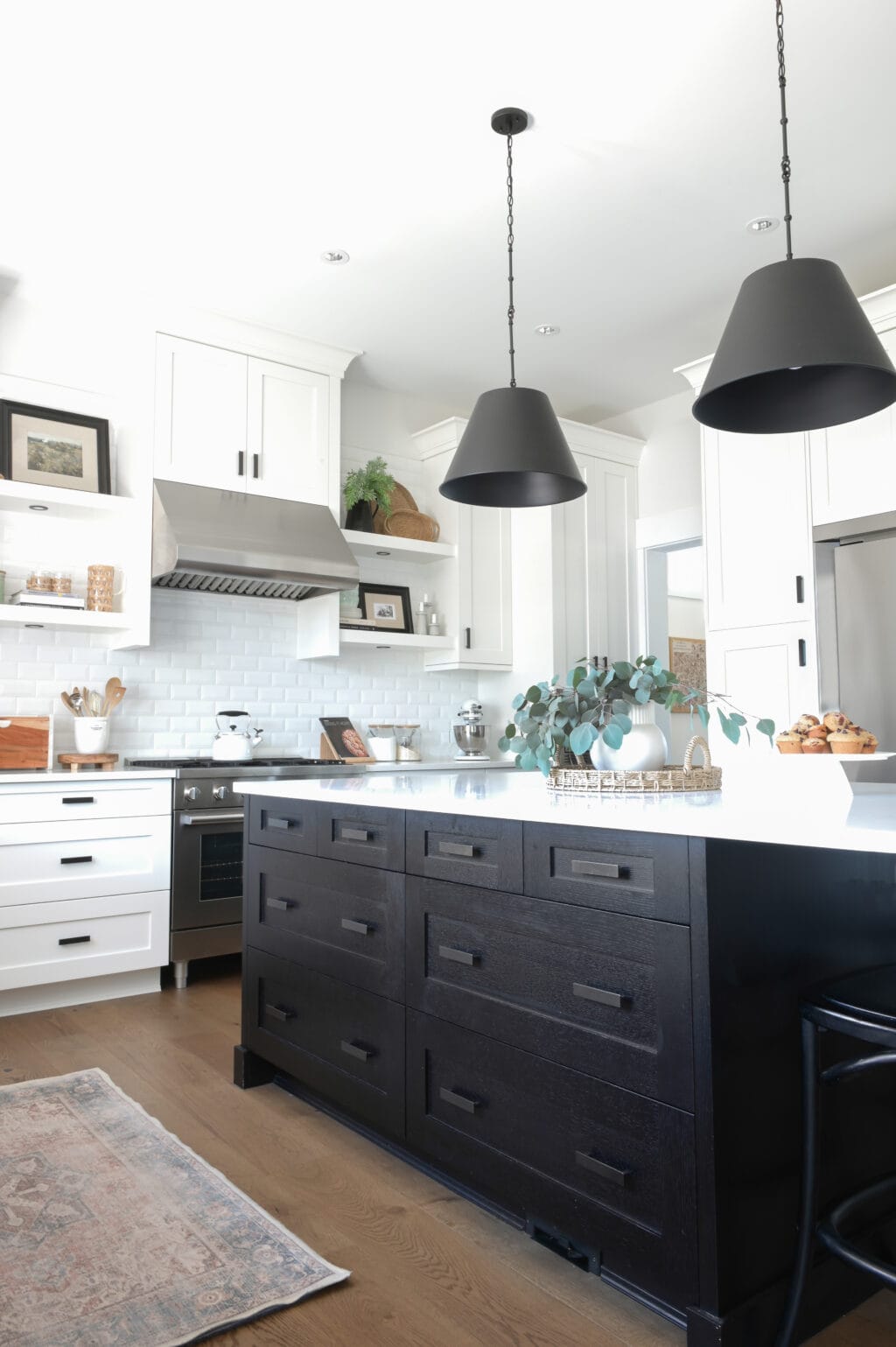 A white kitchen with black pendants