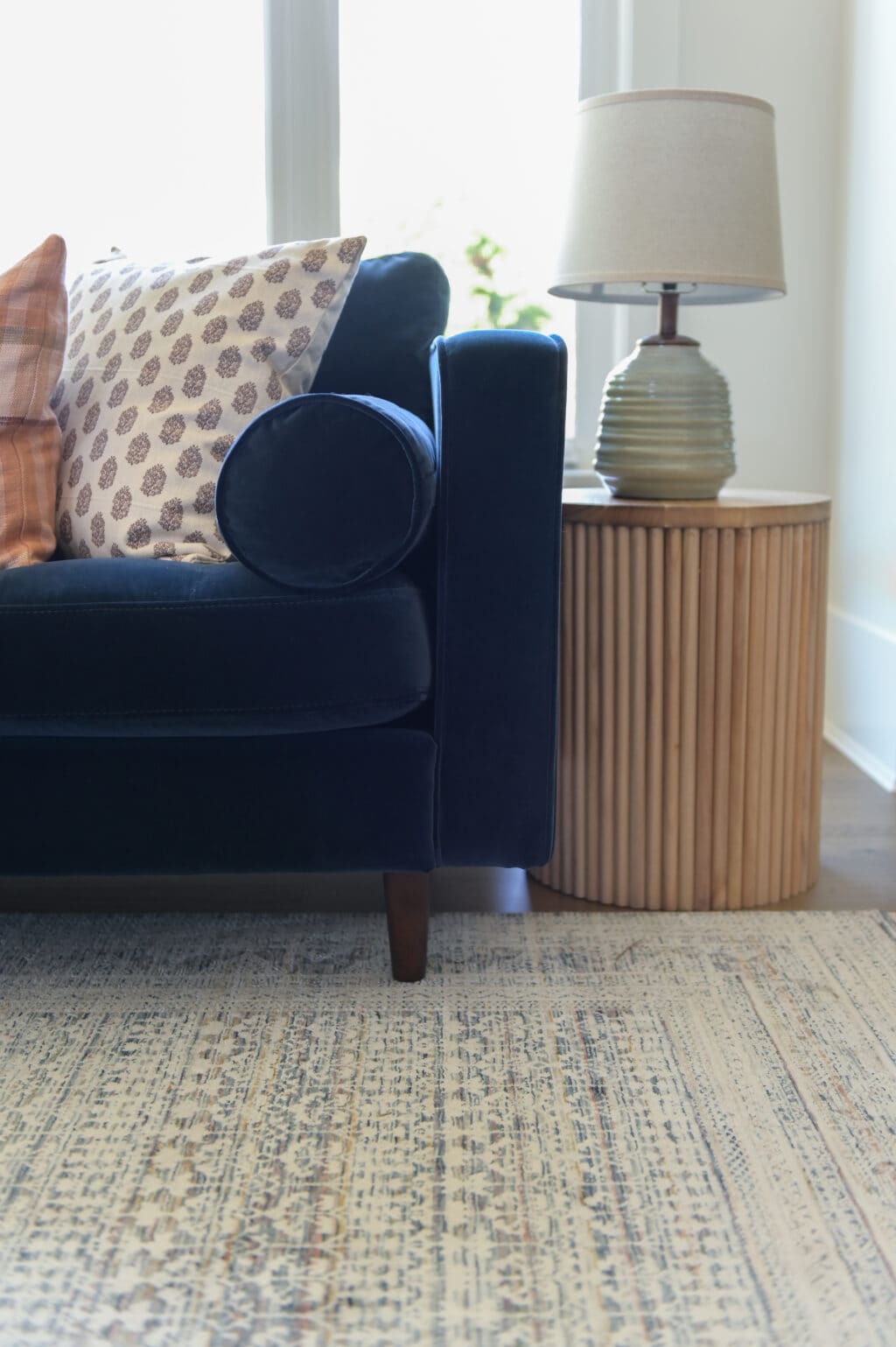 A navy blue velvet couch 