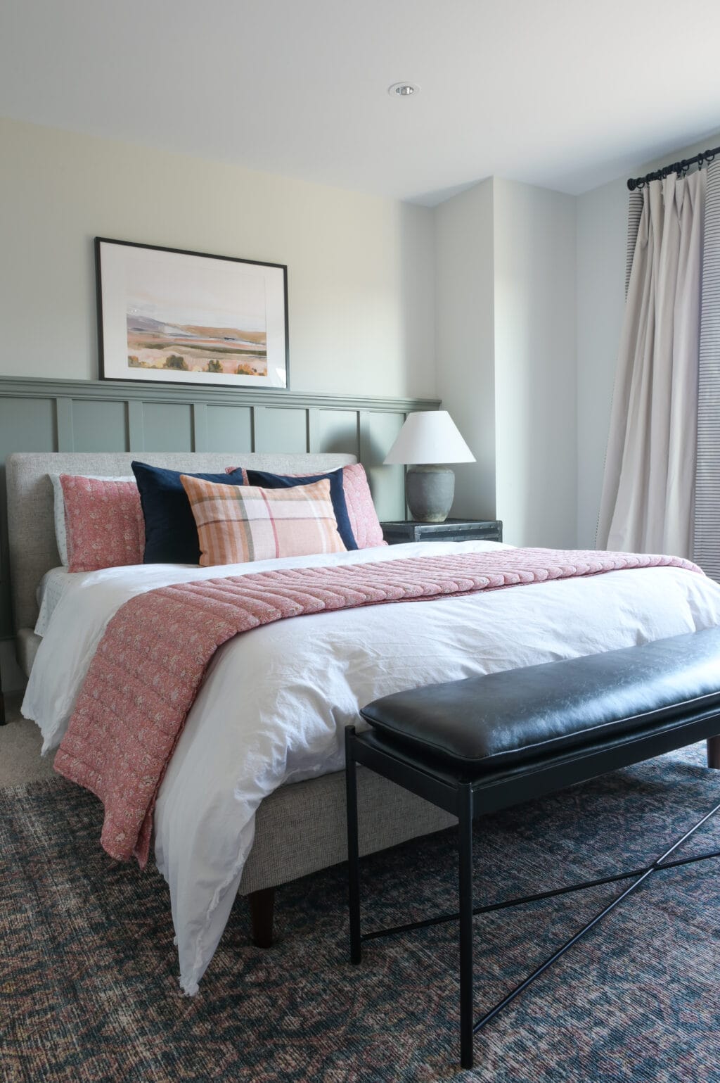 Sage green walls in a main bedroom space 