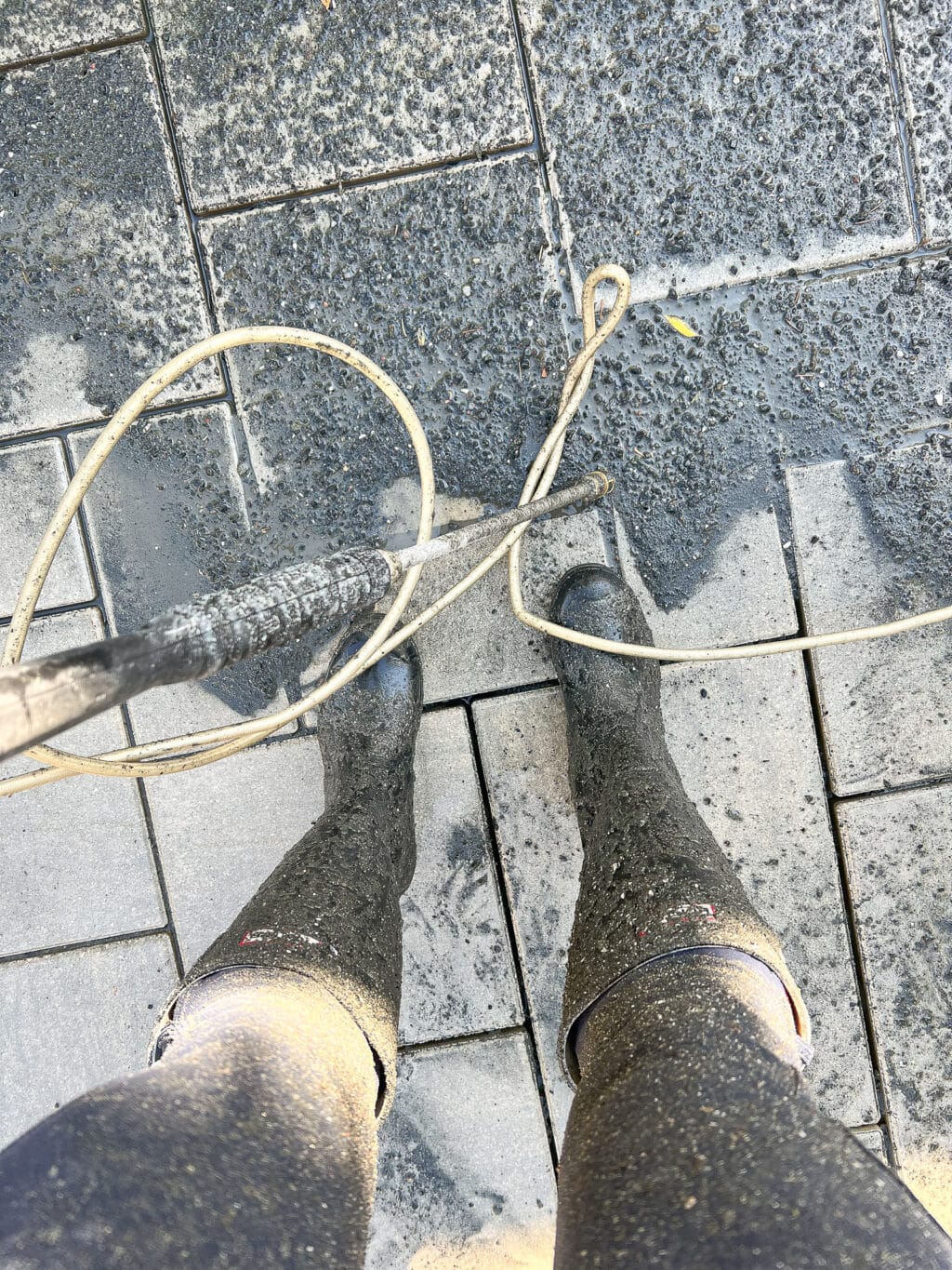 Getting very messy pressure washing the pavers