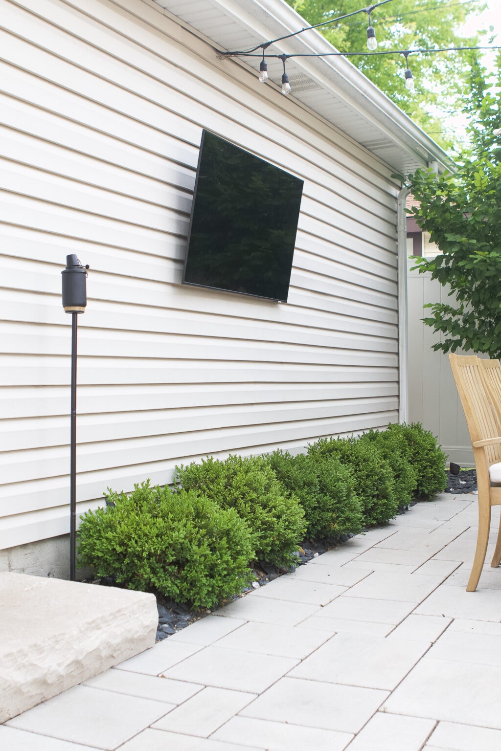 Boxwoods underneath the outdoor tv