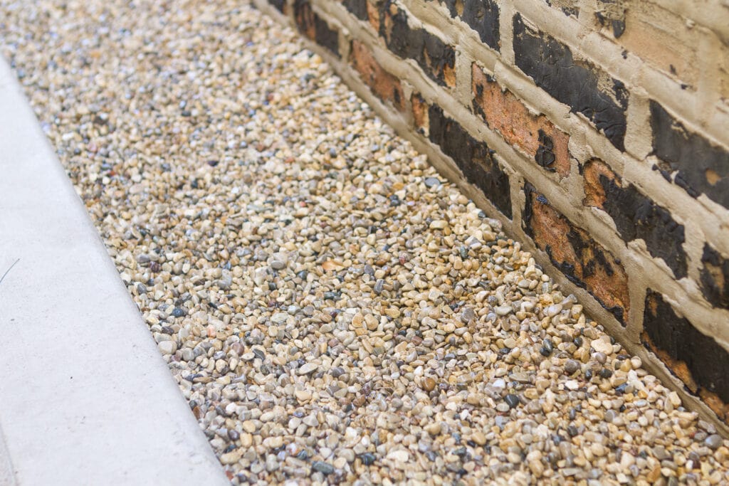 Pea gravel on the side of the house