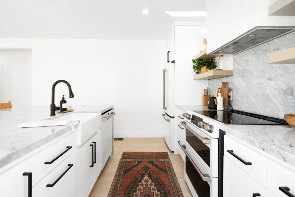 An open concept kitchen with black and white