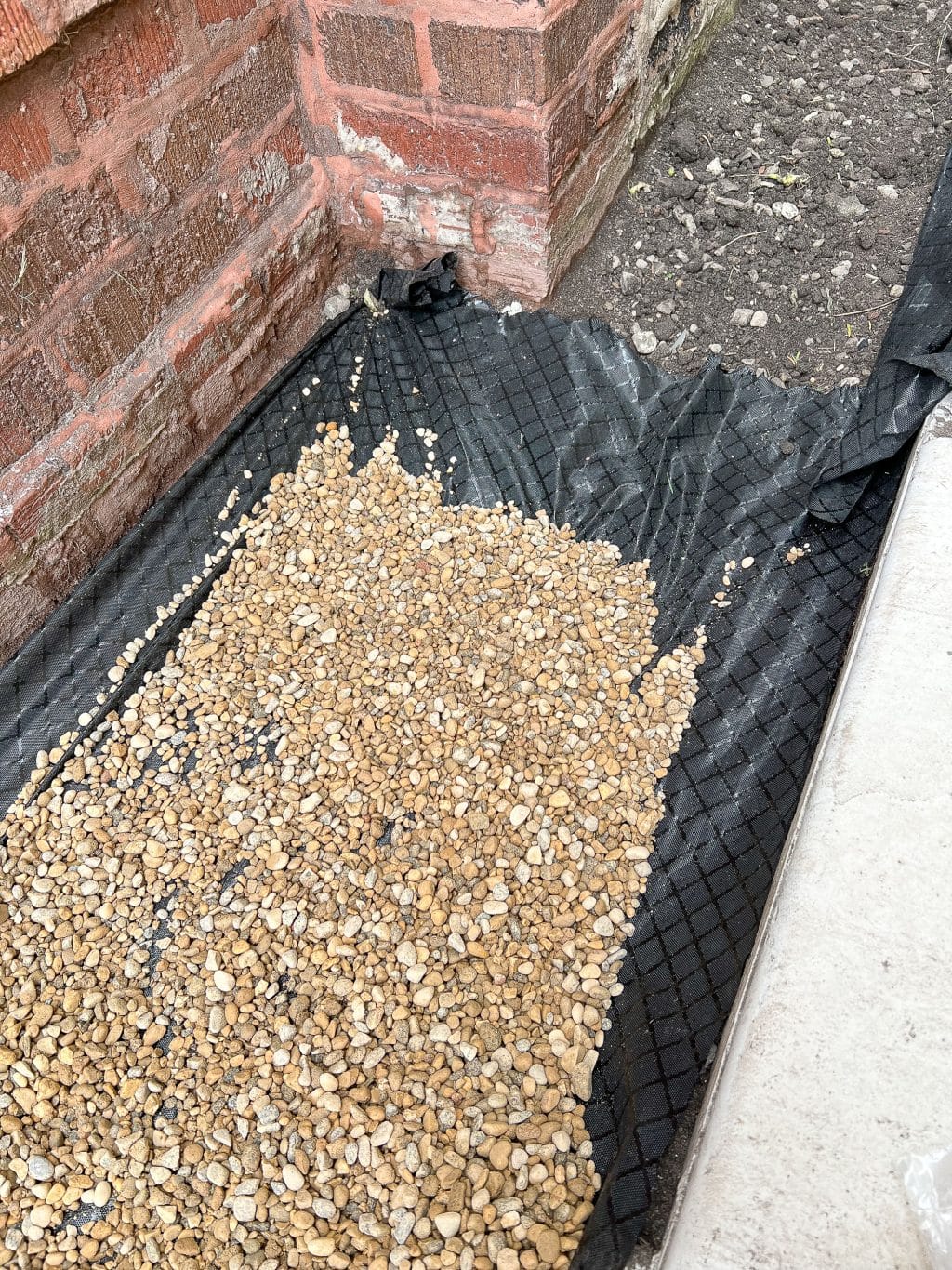 Dumping out the pea gravel to create a pea gravel border