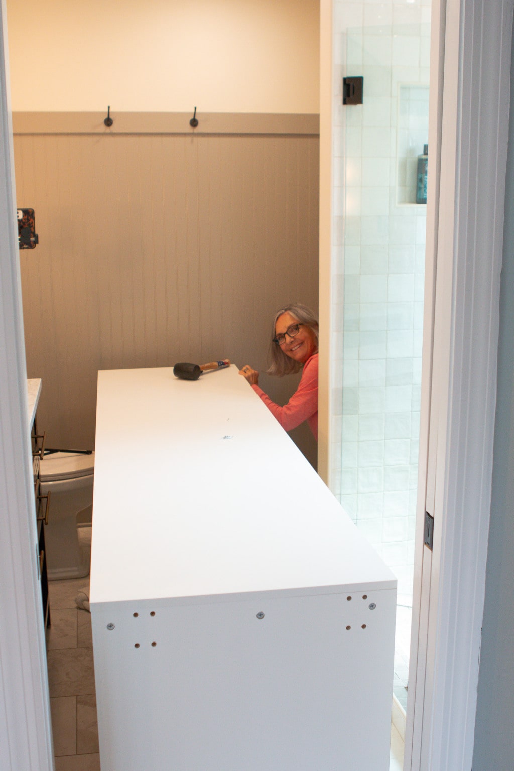 My mom helping me with my diy built in linen cabinet