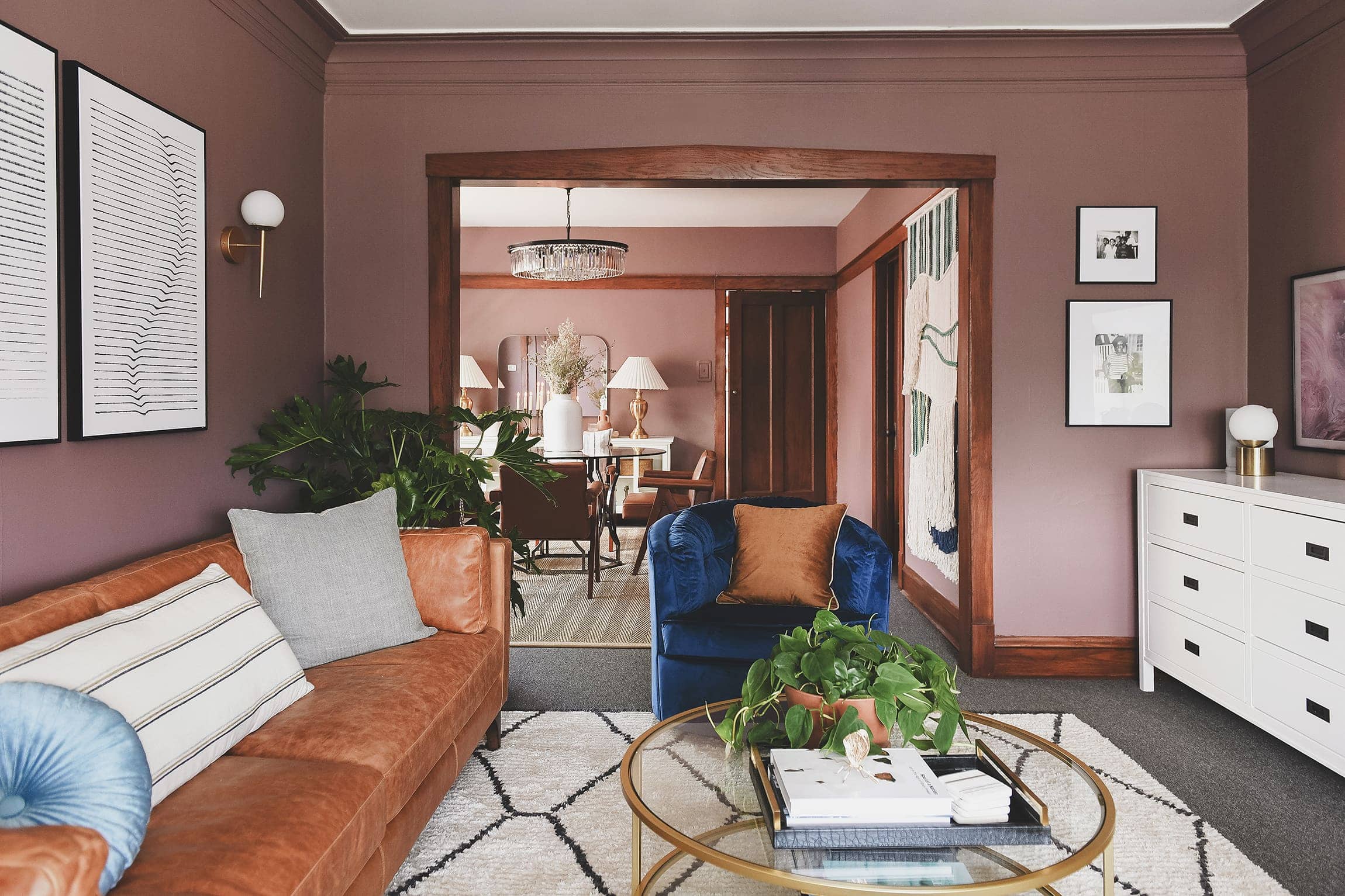 LaTanya's new living room after - with mauve walls, a leather sofa, and modern rug