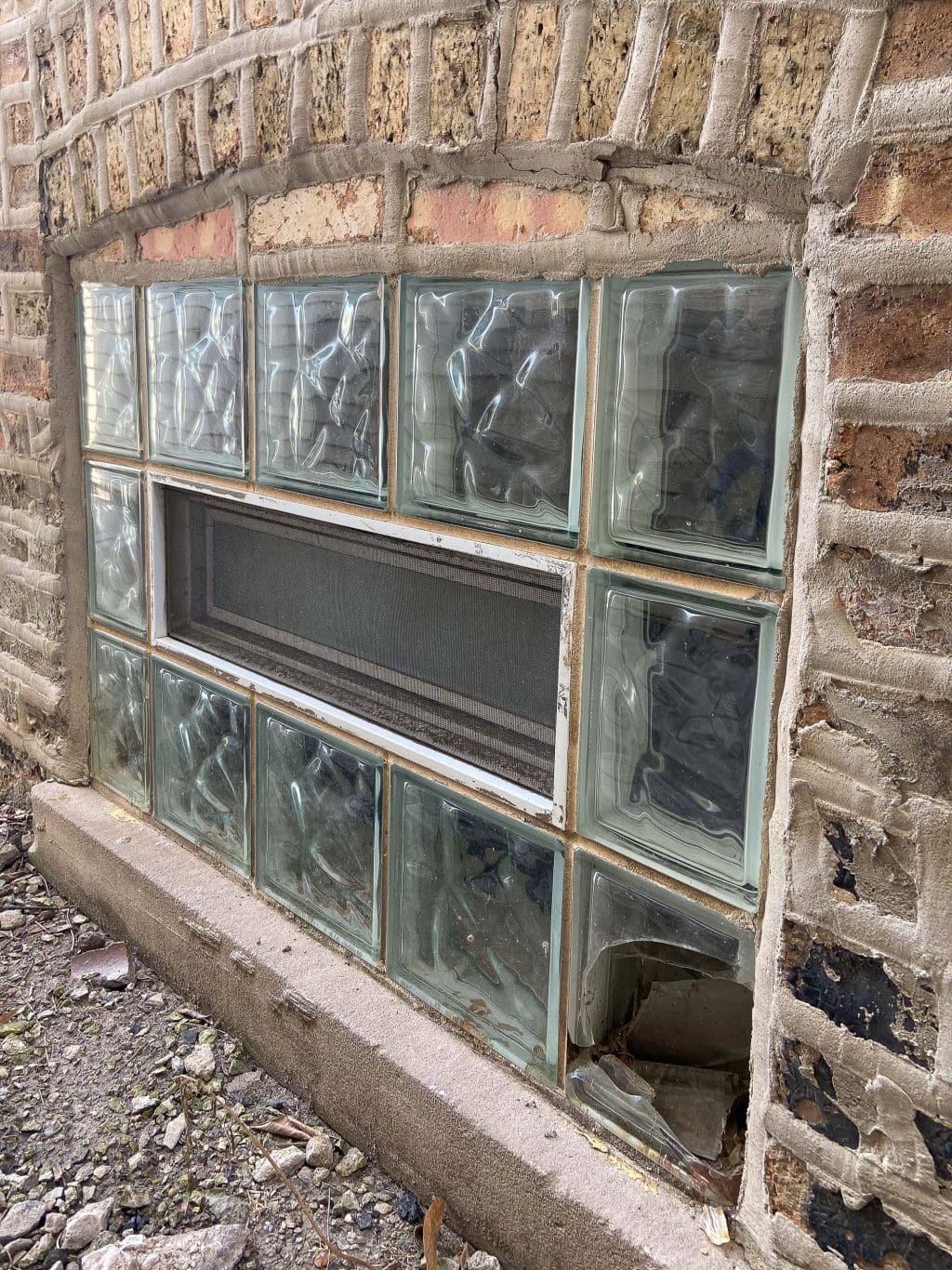 Broken glass block windows in our basement