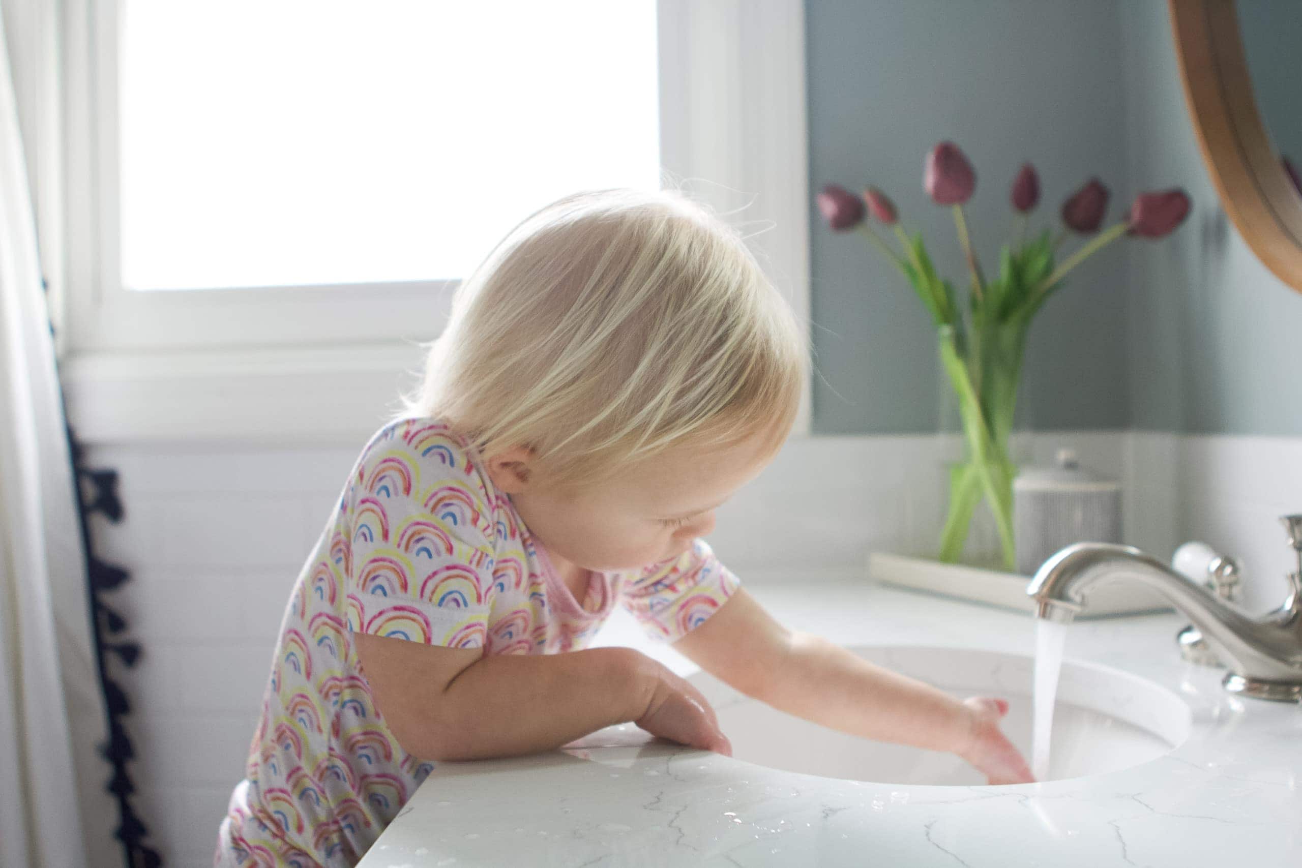 Rory washing her hands in the kids' bathroom