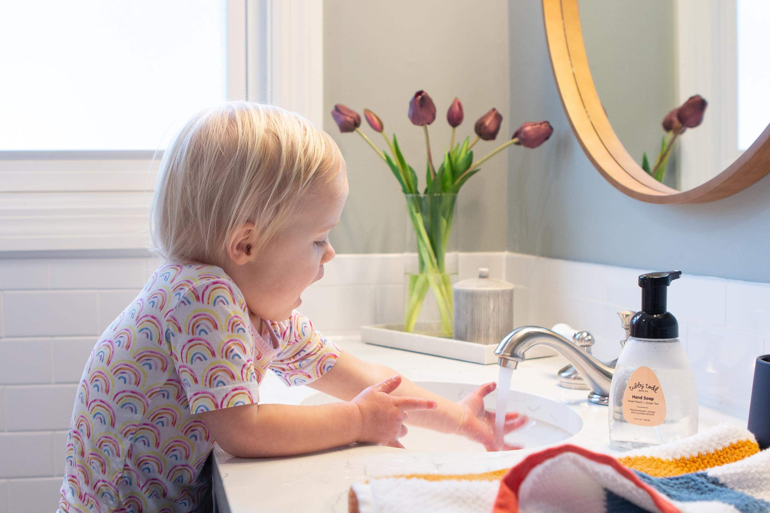 Rory using the sink in the kids' bathroom