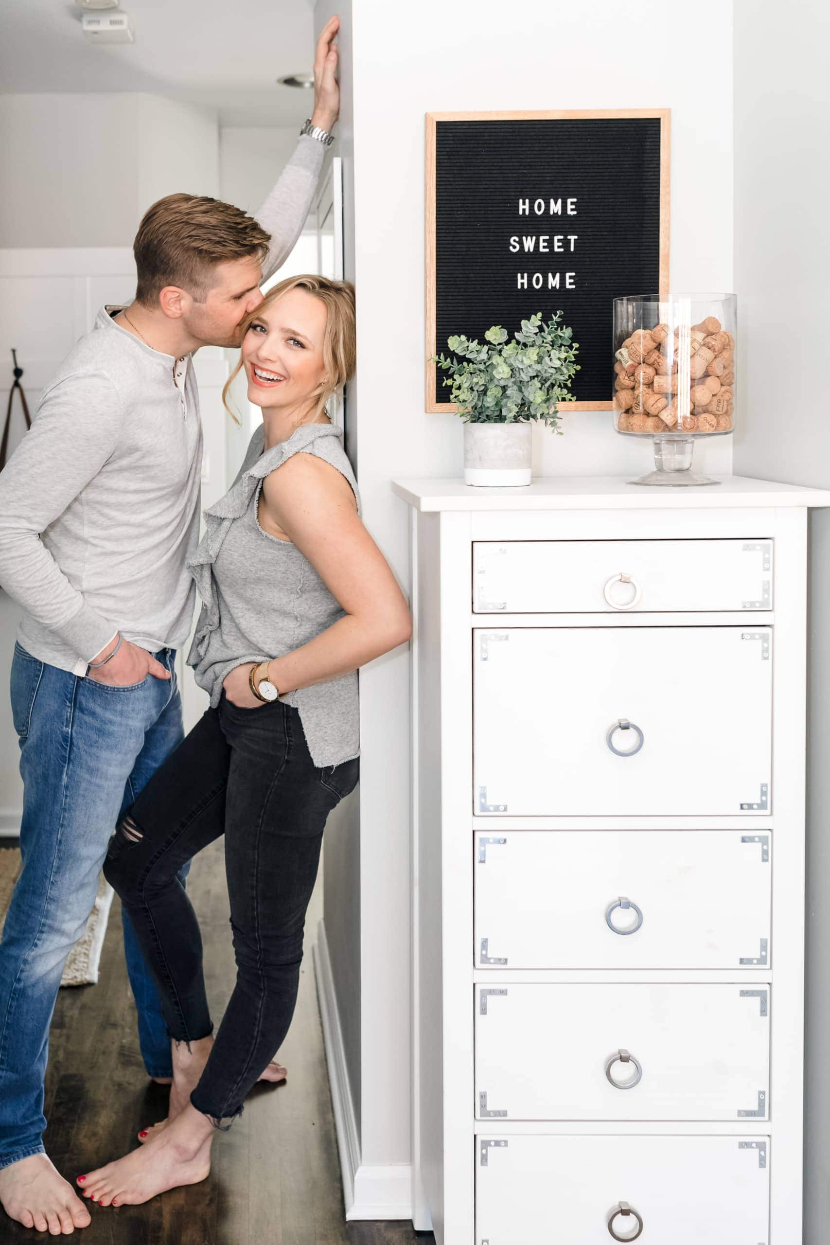 Casey and Finn with home sweet home sign