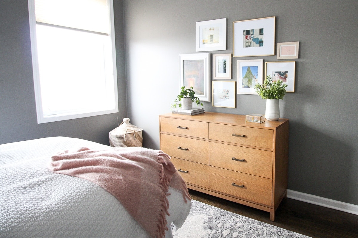 Wood dresser in a gray bedroom