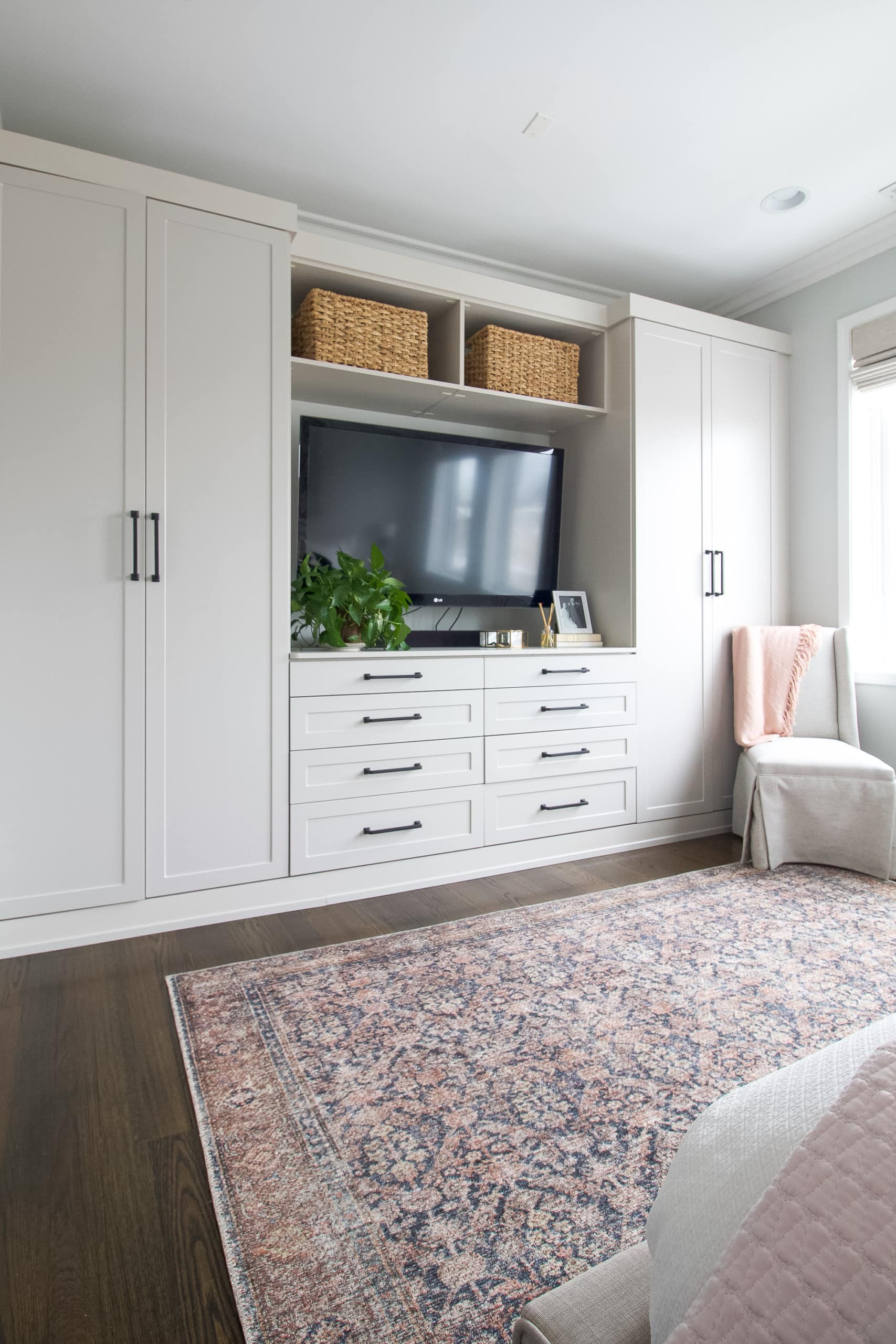 A wall of built-ins in a master bedroom