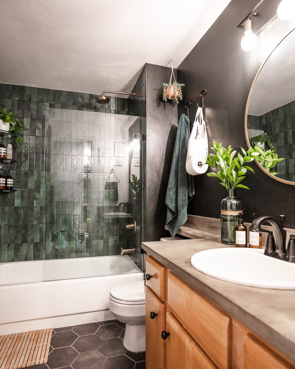 dark moody bathroom with green wall tlie