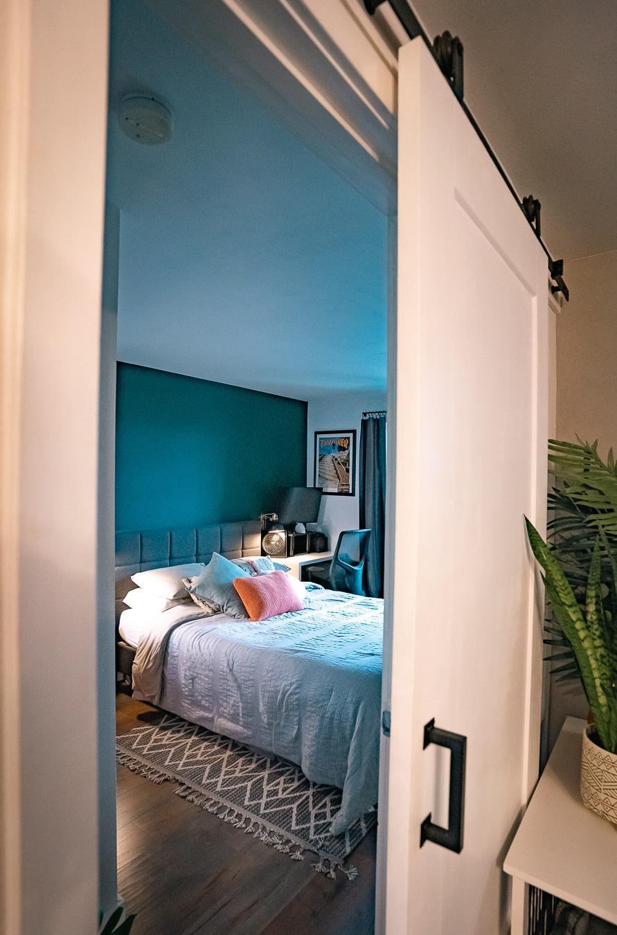 bedroom barn door in this moody condo