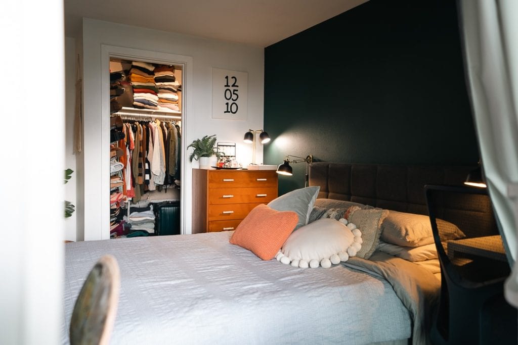 earthy bedroom with moody green wall color