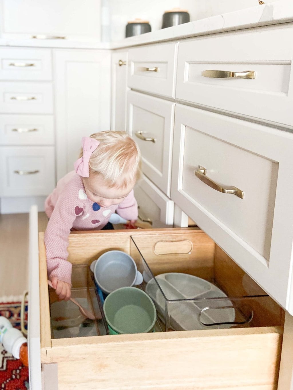 Rory helping put away items in the kitchen