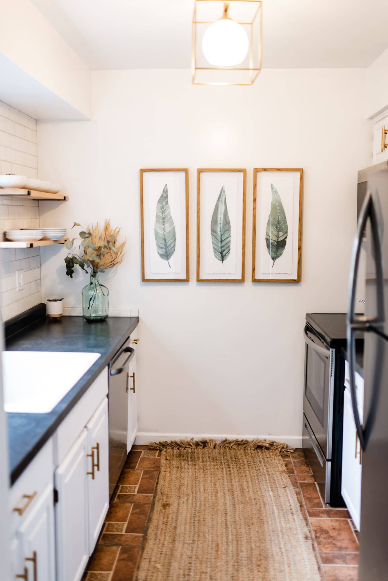 boho galley kitchen with leaf artwork 