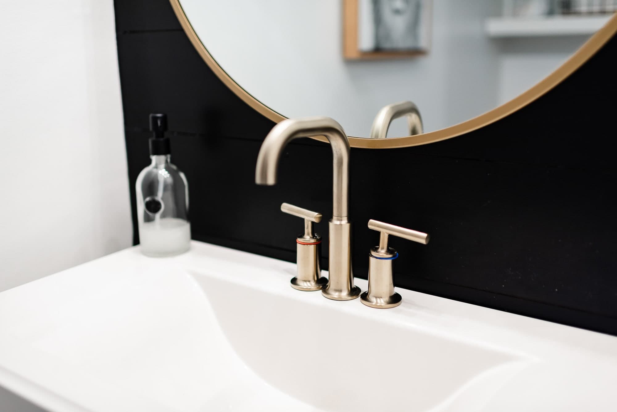 Gold faucet in a farmhouse condo bathroom