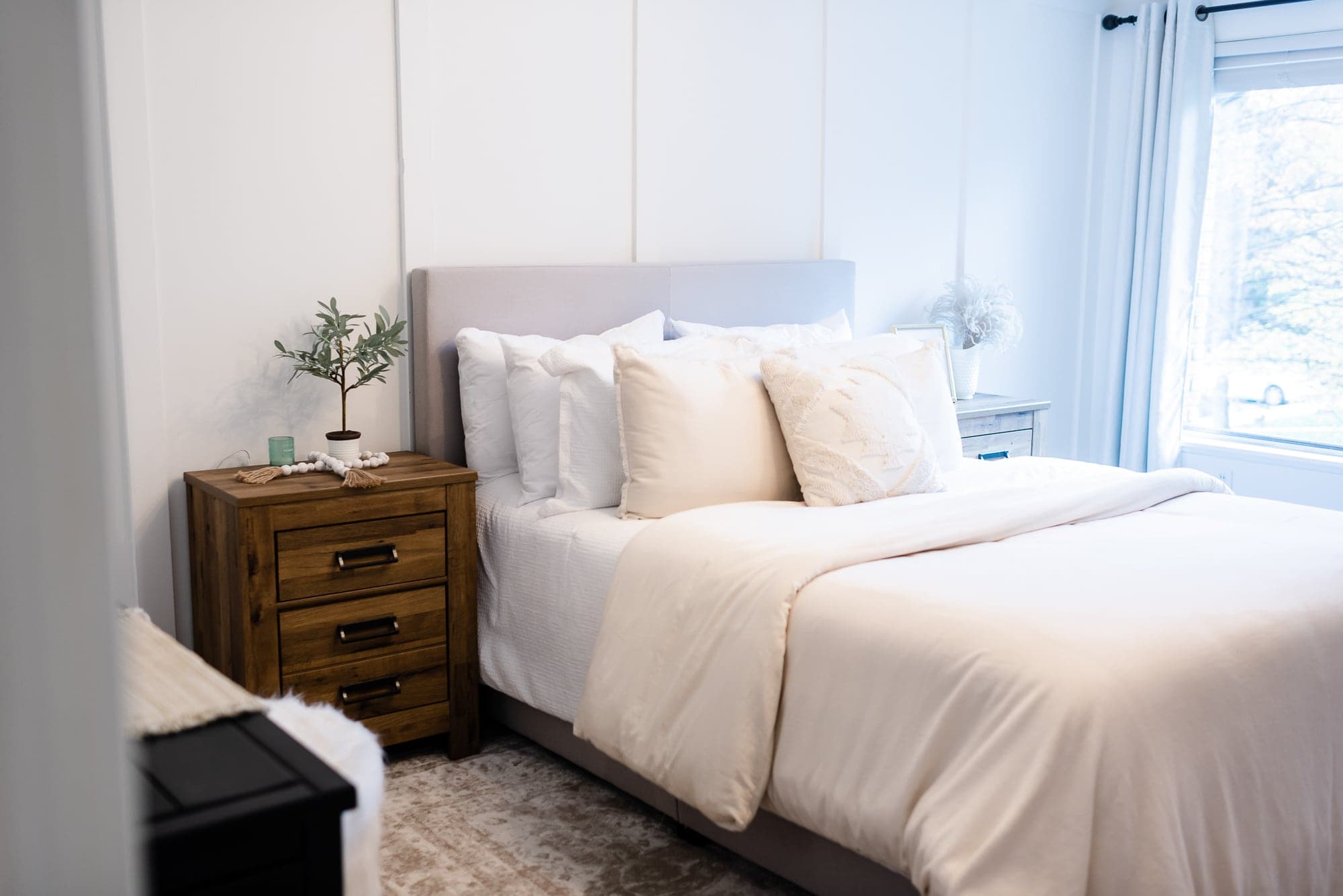 A neutral bedroom in a farmhouse condo