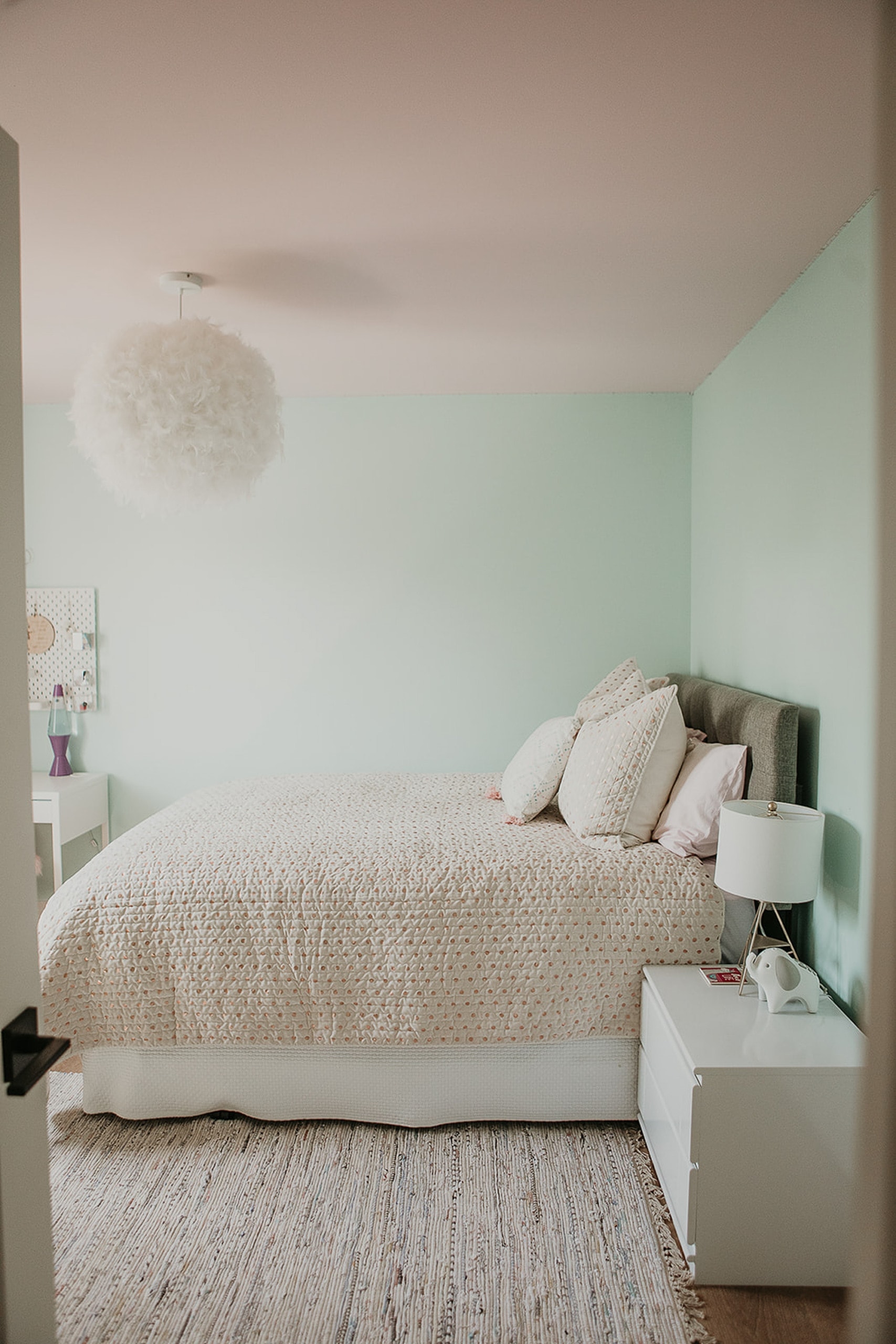 Light green walls in a girls room