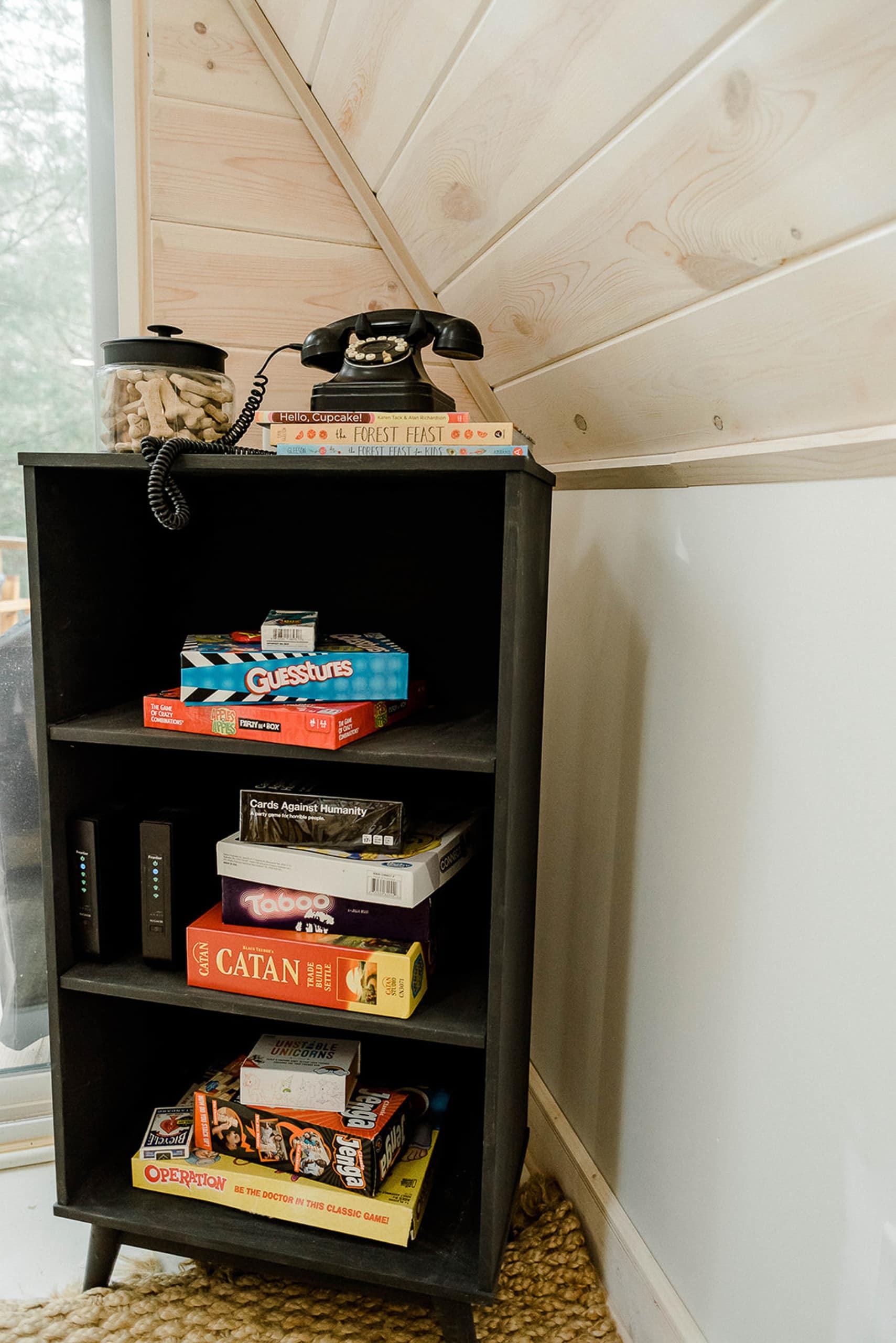 Bookshelf in the corner with games on it