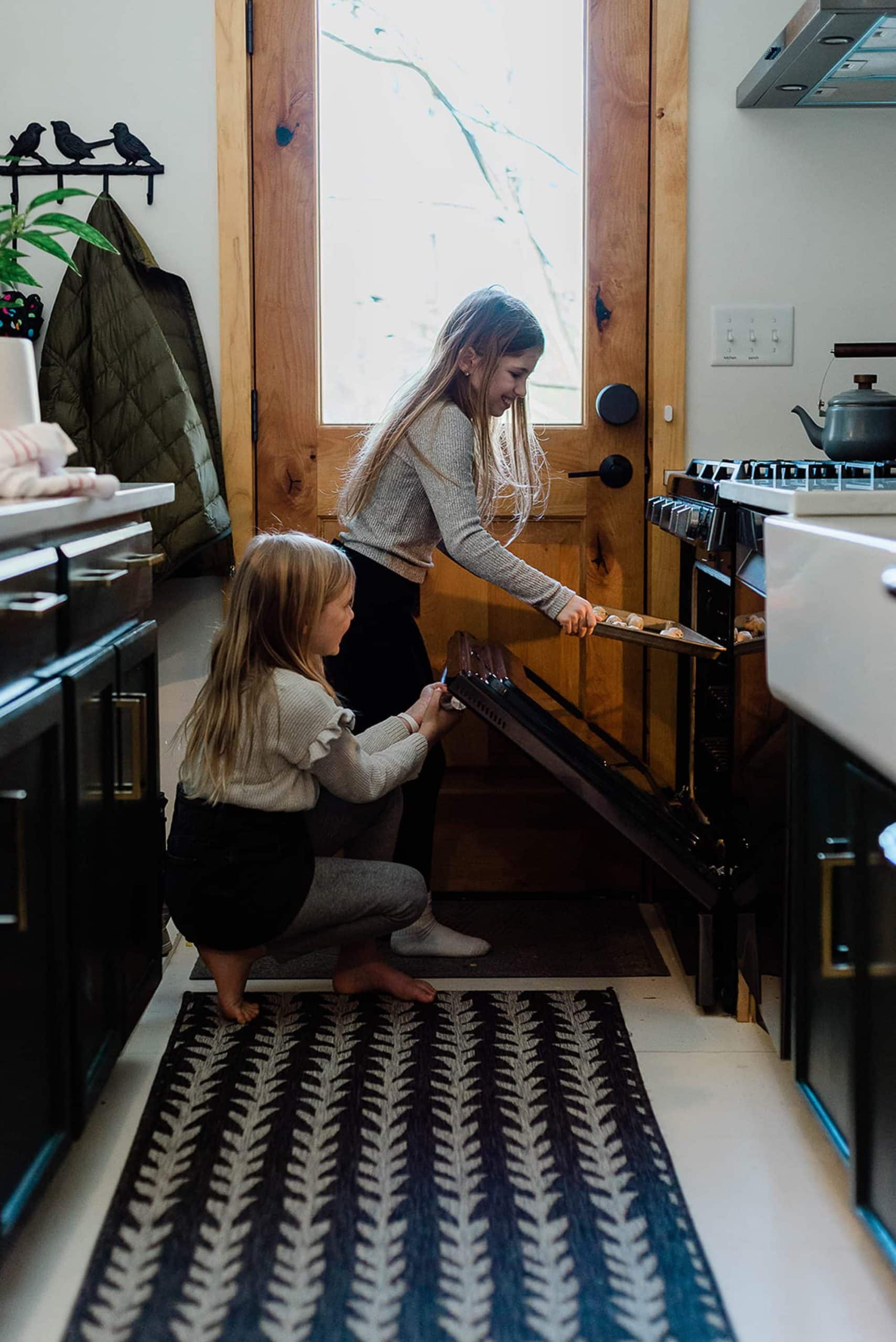 The girls making cookies in the kitchen