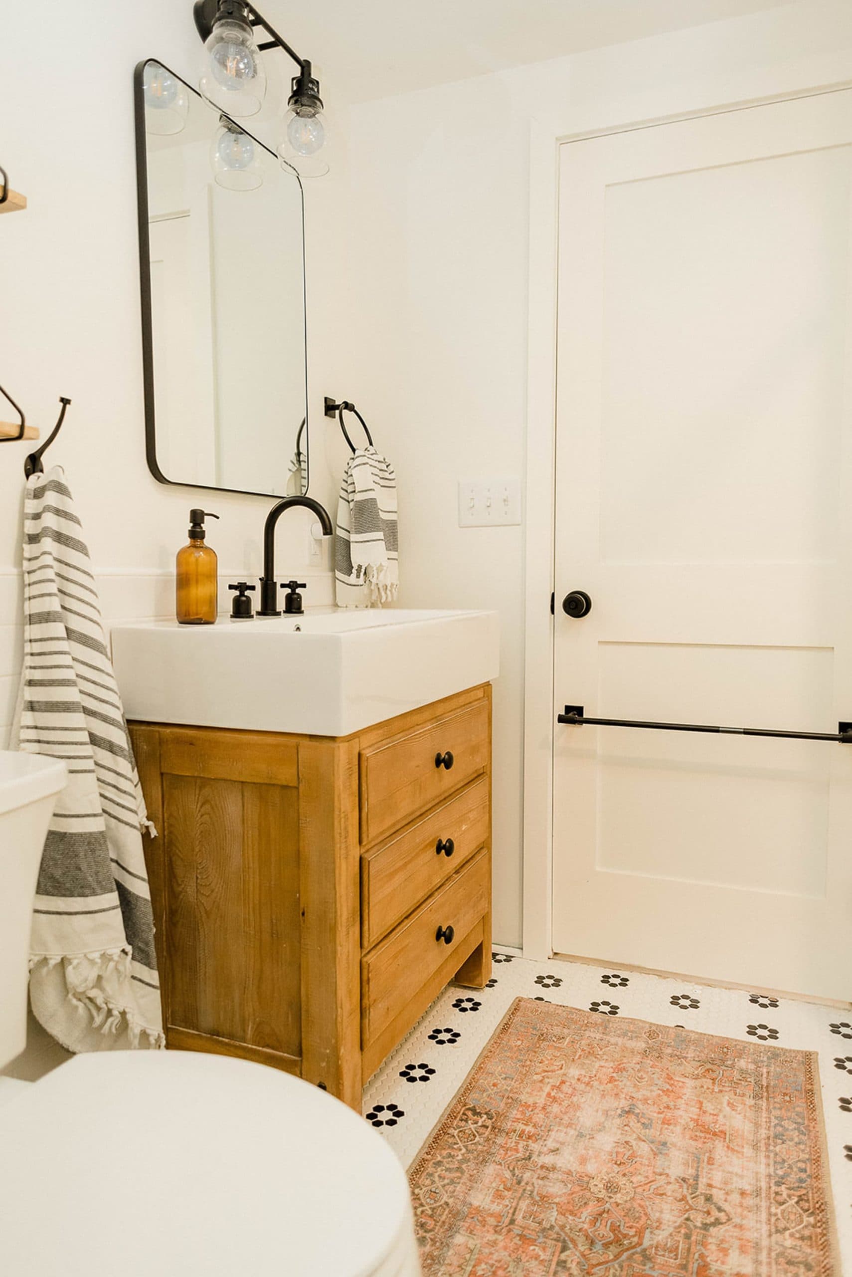 Wood vanity and black faucet